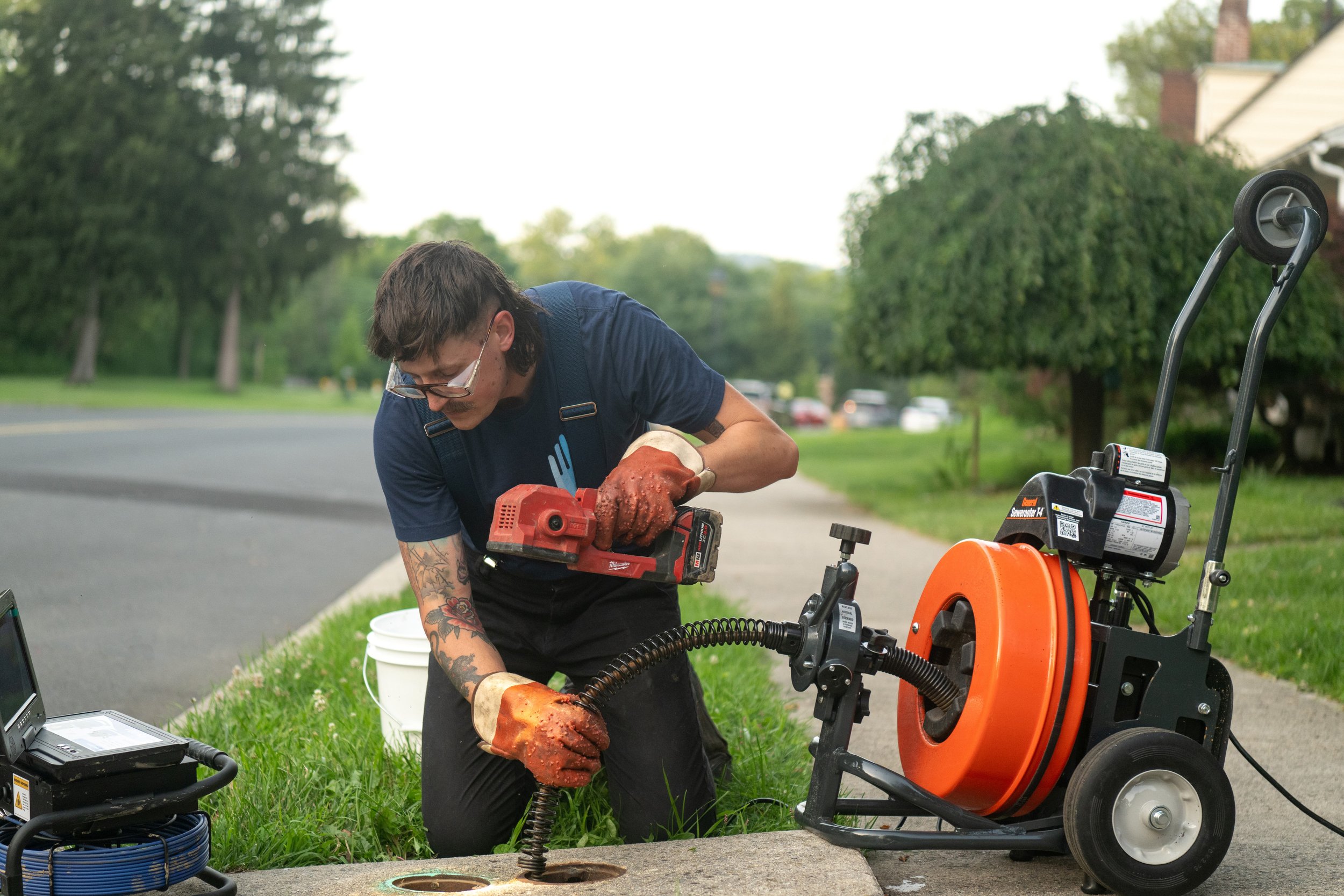 Choice plumber using a drain snake