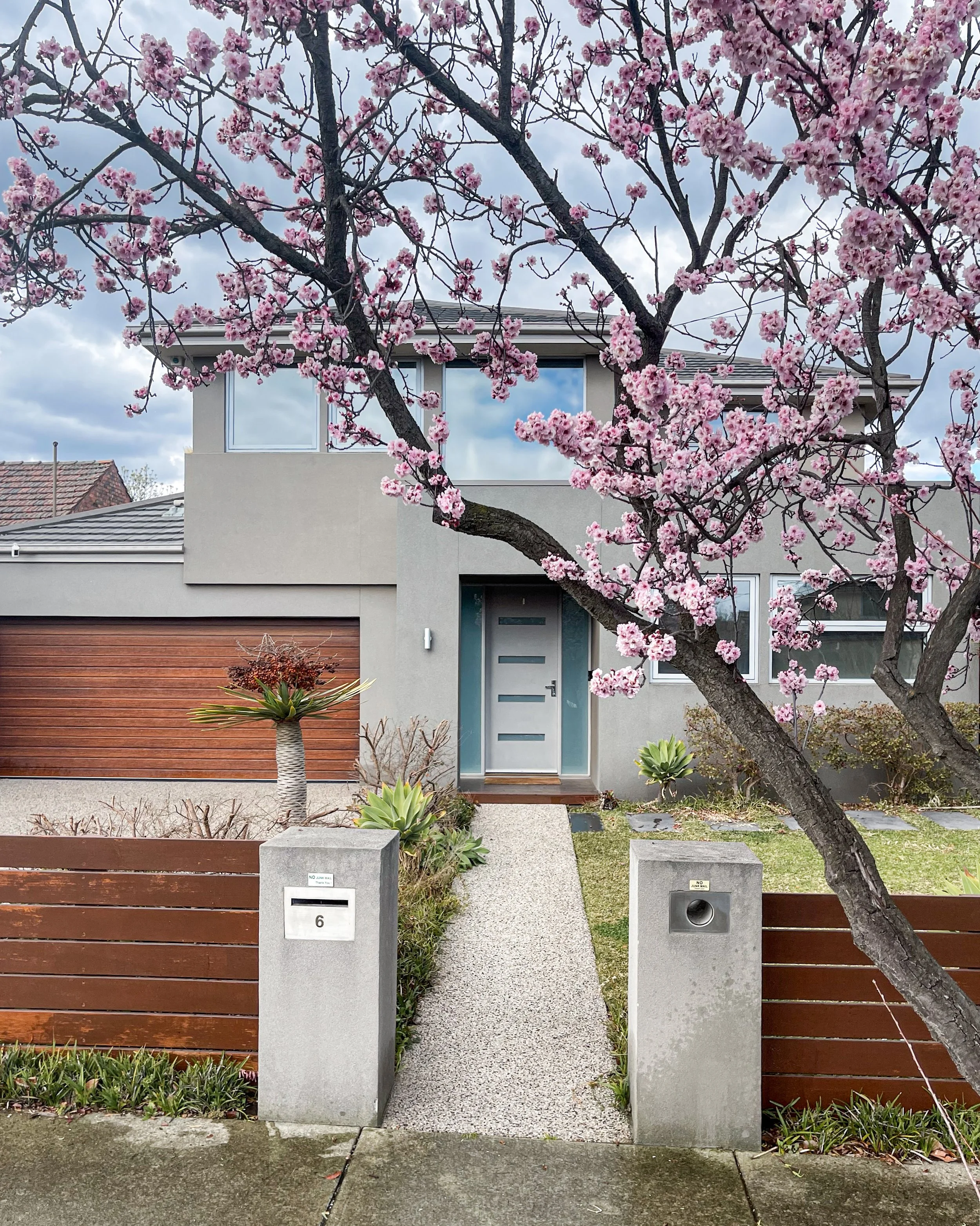 Facade washing and driveway cleaning for modern render home Melbourne — SUDS Group exterior cleaning