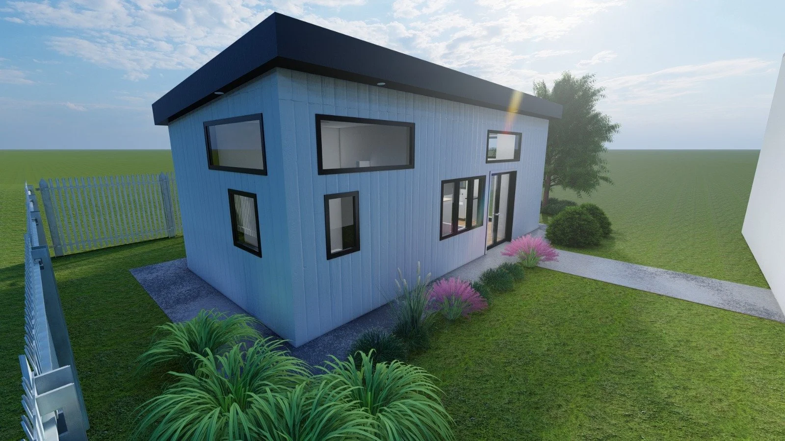 Modern two-story house with white siding, black window frames, and a black roof, situated on a grassy lawn with a gravel pathway, pink flowering bushes, a small tree, and a wooden fence.