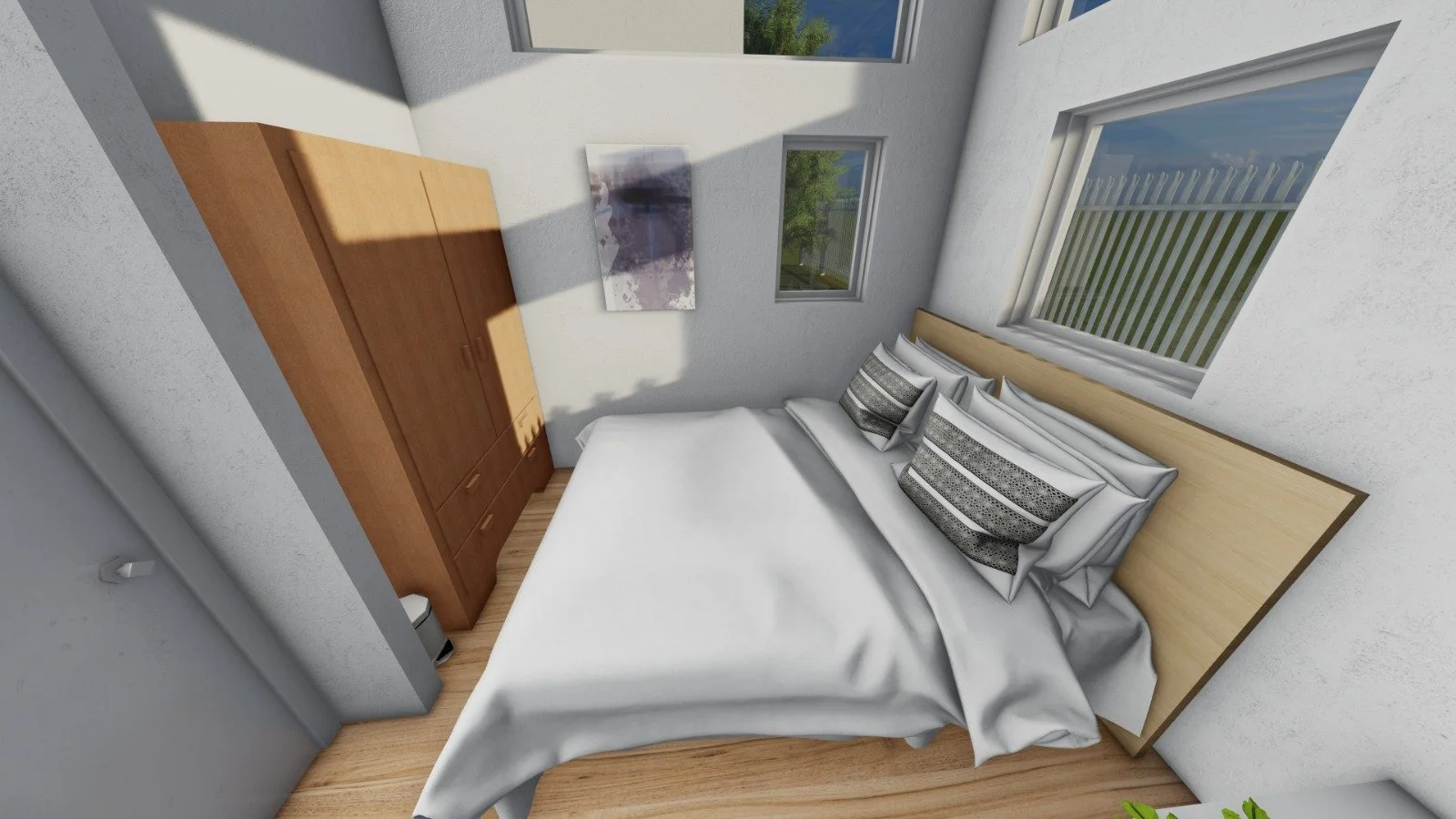 A bedroom with a bed, pillows, wooden wardrobe, and four windows showing trees and sky outside.