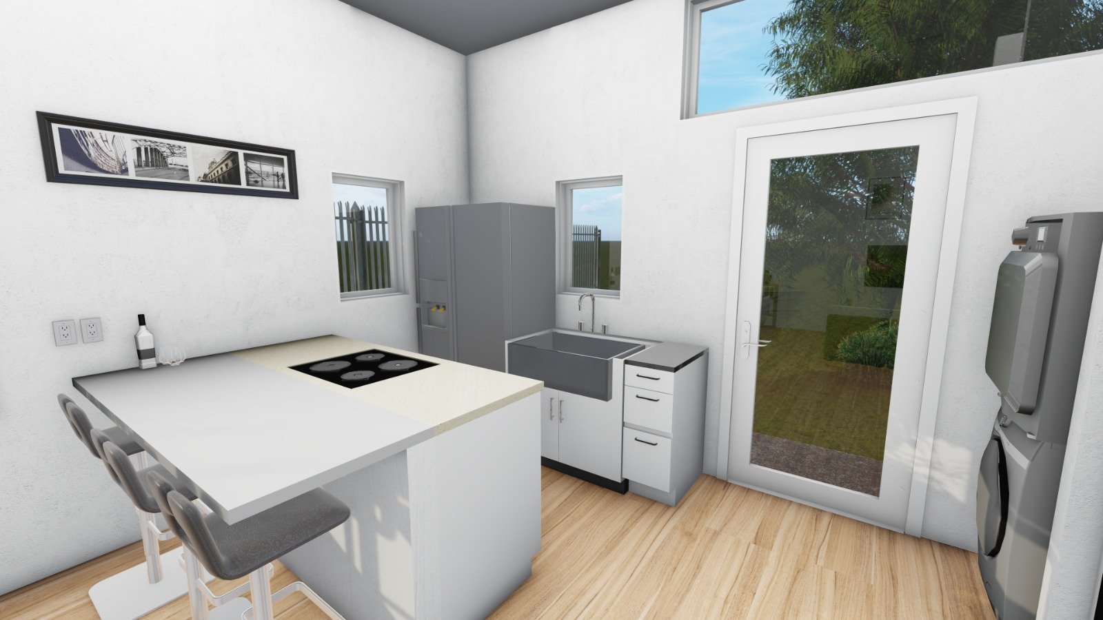 Modern kitchen with white walls, light wood flooring, gray refrigerator, stainless steel sink, black stove, countertop, and a white door leading outside. There are two small windows and framed black and white photo on the wall.