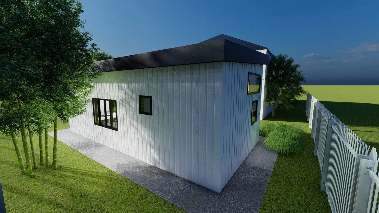 A modern house with vertical white siding, black window frames, and a dark roof, surrounded by green grass, trees, and a white fence, on a sunny day.