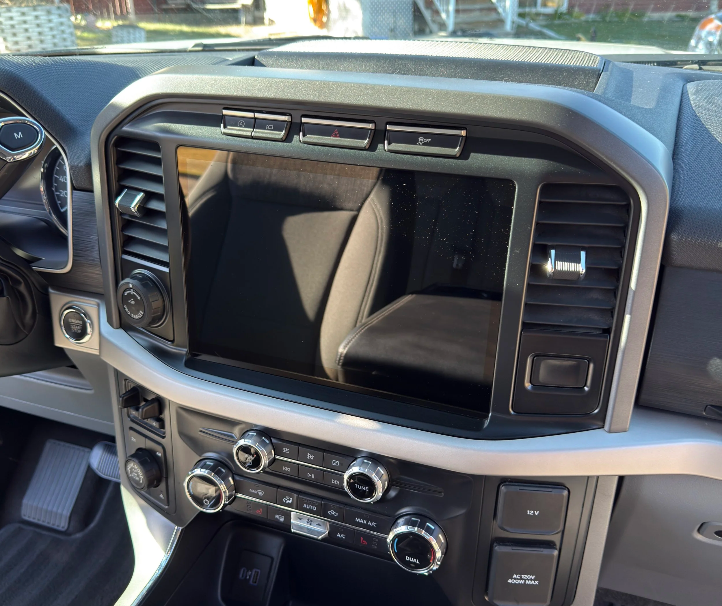 Detailed and sanitized dashboard and infotainment center of a vehicle after interior cleaning.