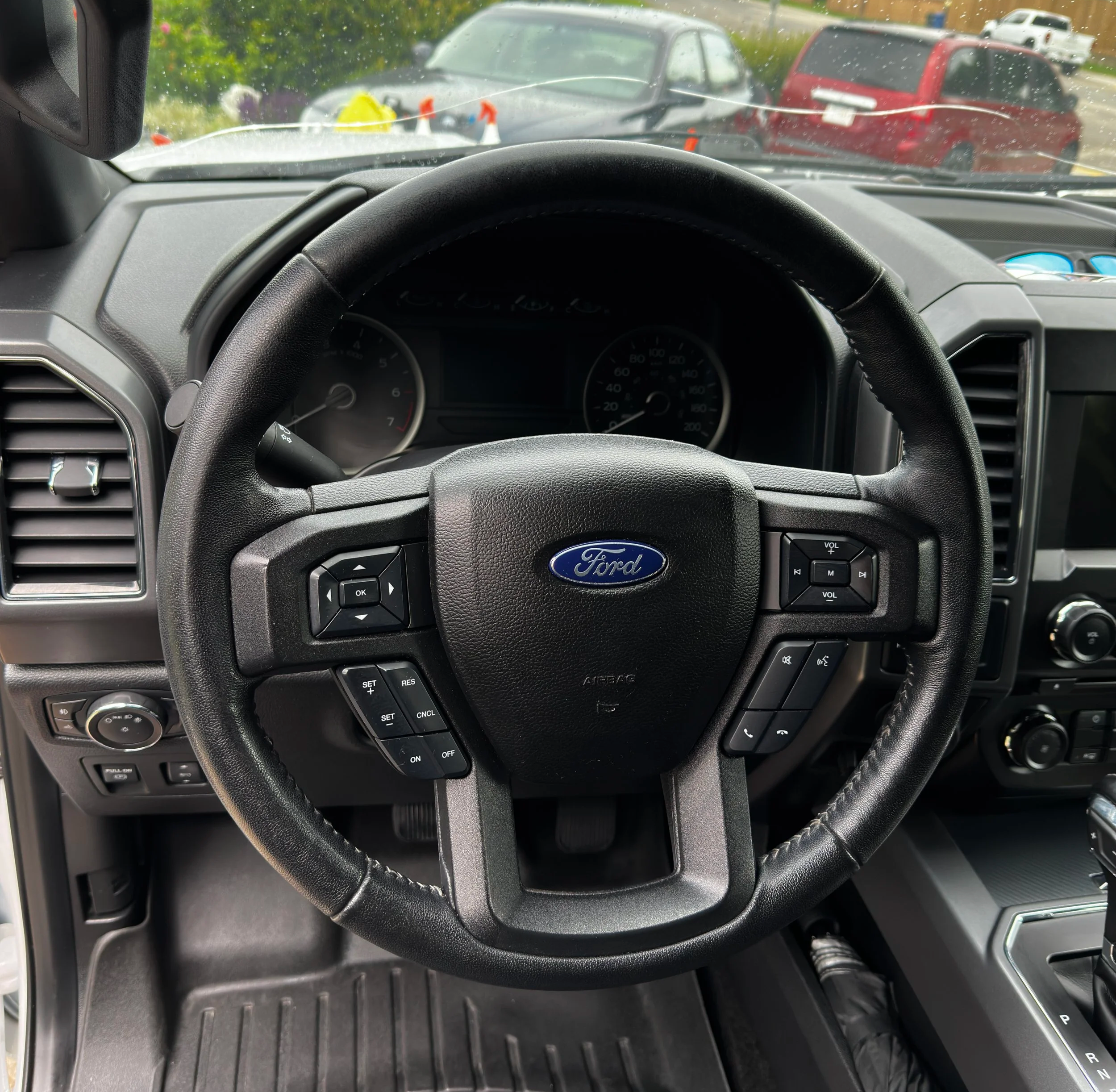 Steering wheel and dashboard fully cleaned, sanitized, and protected after our full detail service.