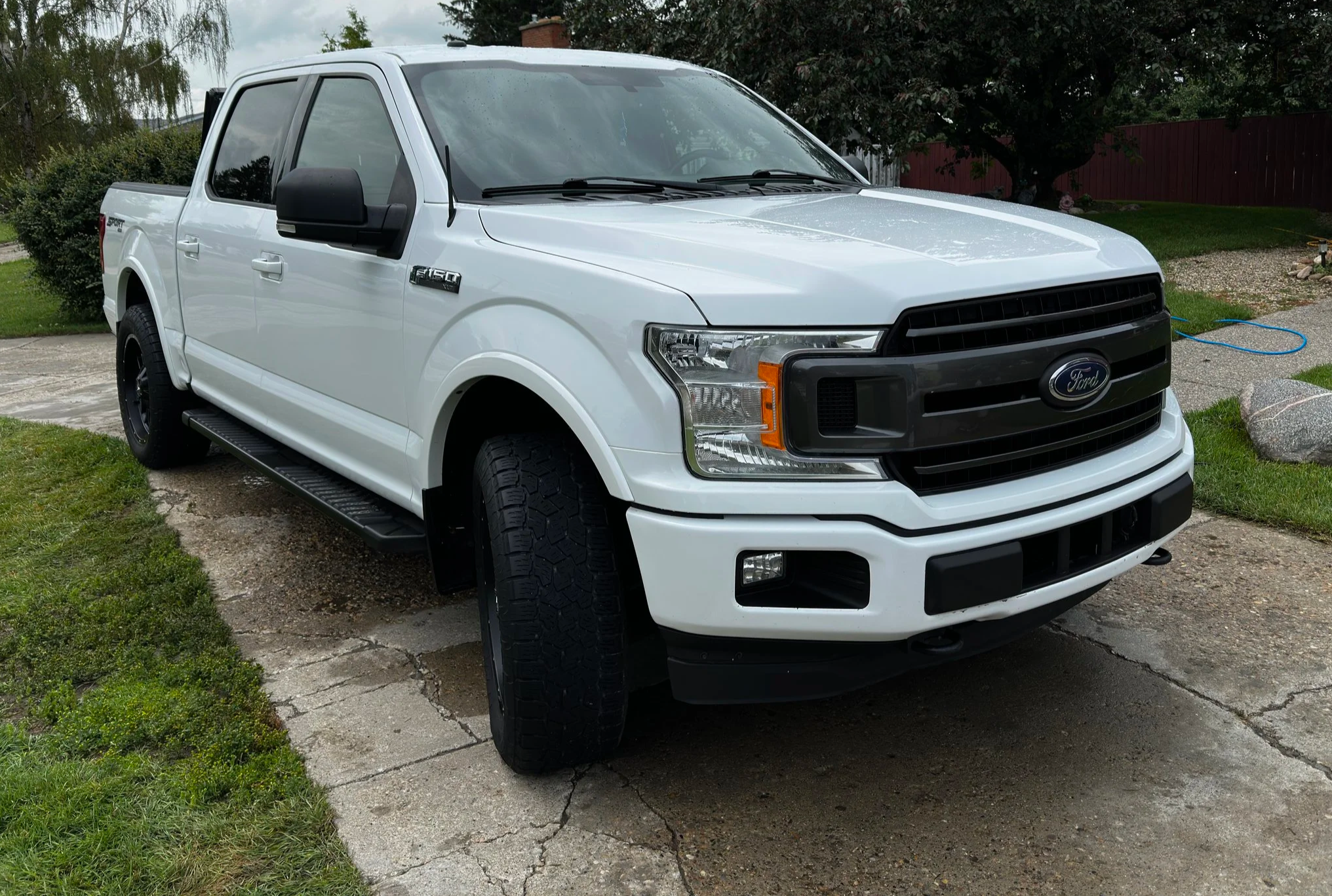 Gloss white finish and tire shine after professional exterior detailing for a truck in Didsbury.