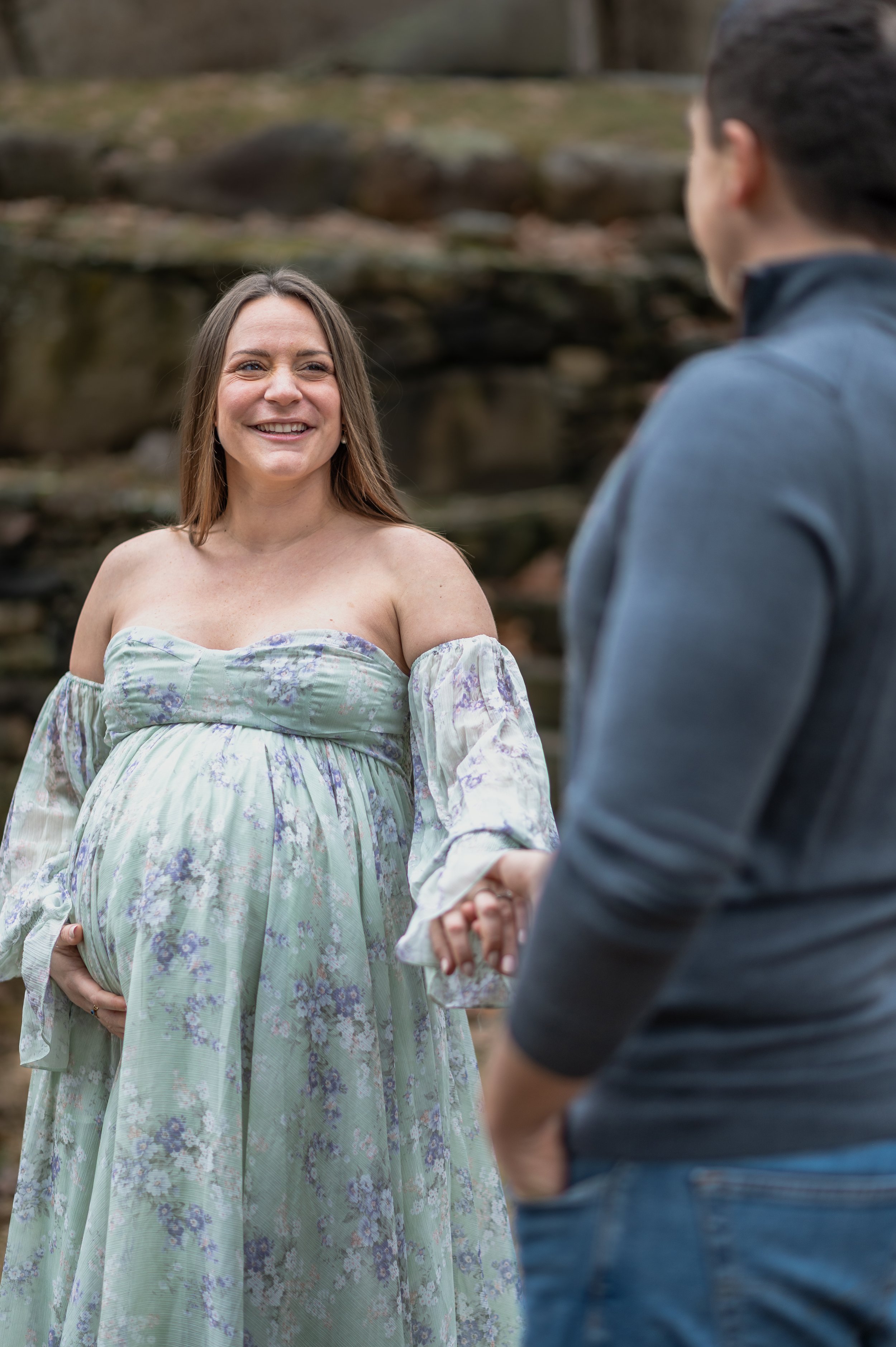 A husband looks on at his beautiful pregnant wife