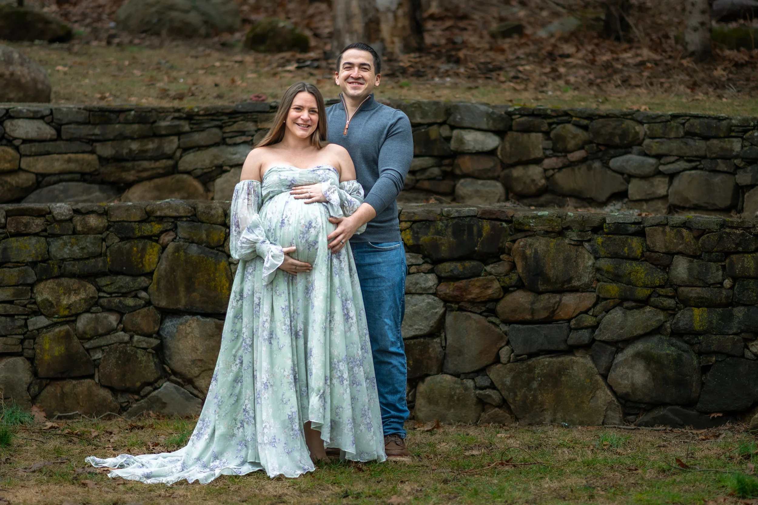 A couple poses for the camera during their maternity photo session