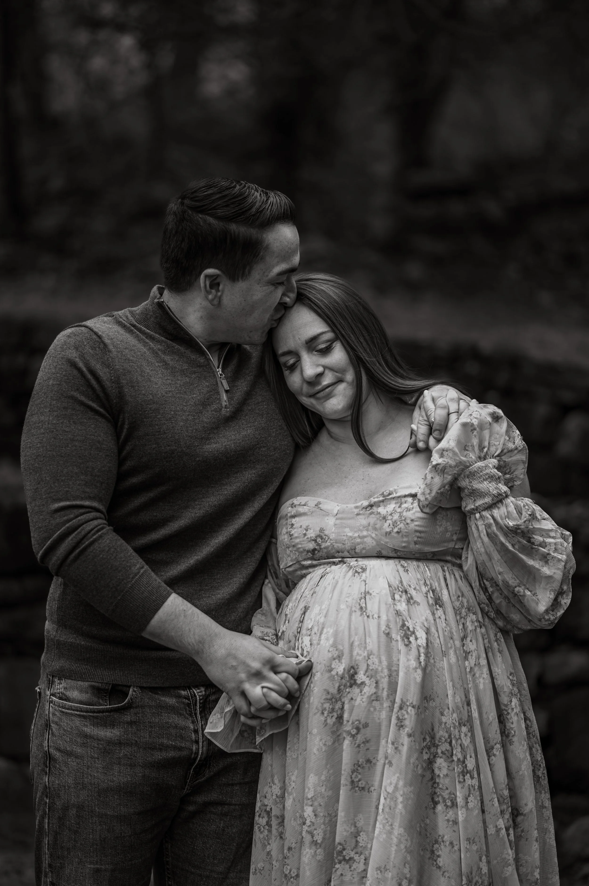 A black and white image of an expectant couple