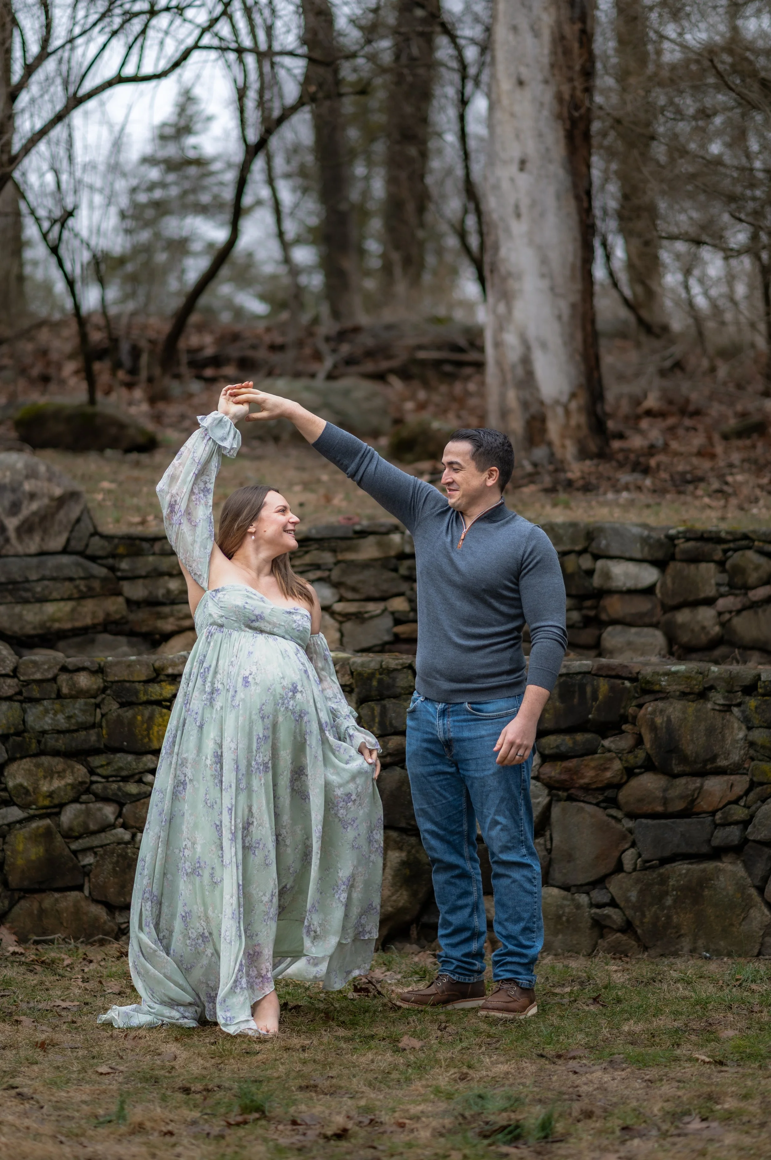 A couple expecting their first child dancing together