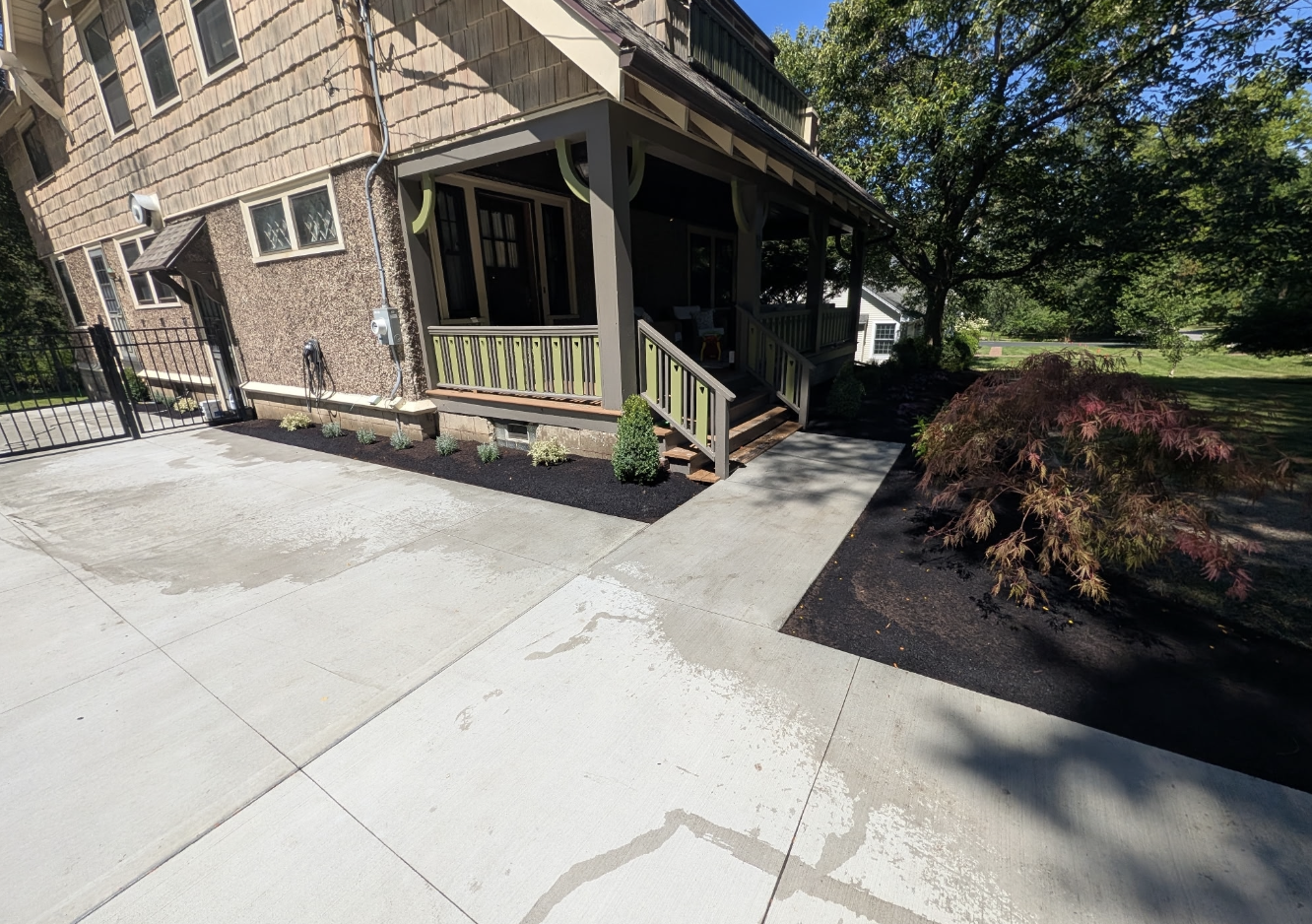 Completed front yard landscape installation with new plants and mulch in West Seneca NY