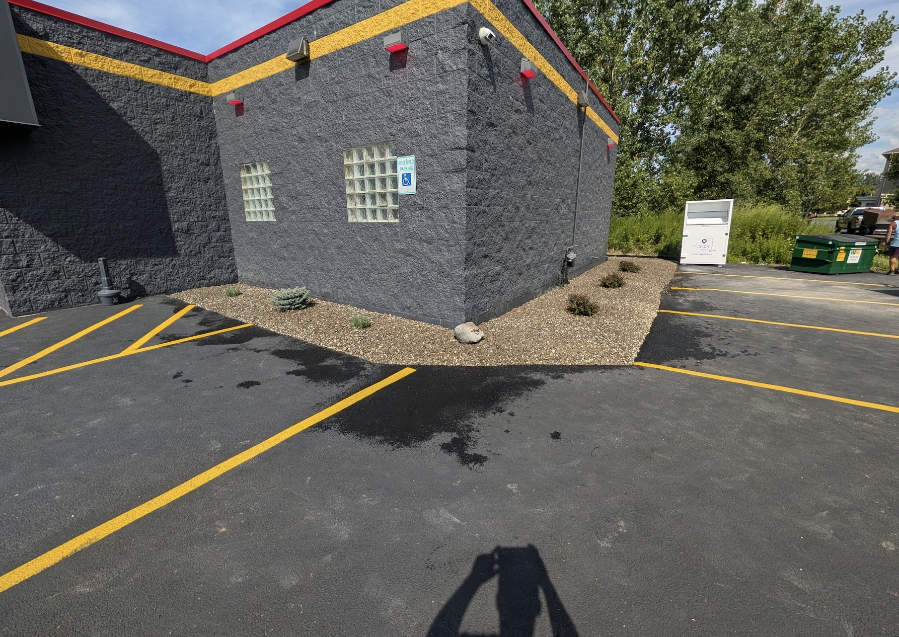 Commercial landscape installation with decorative stone and new shrubs by Kielty Landscaping Services