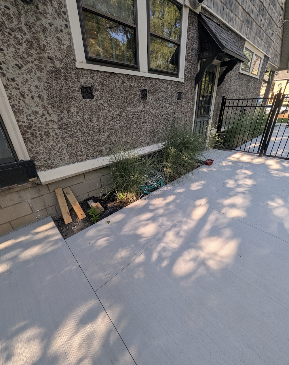 Before photo of old landscaping being prepared for tear out and replacement in West Seneca NY