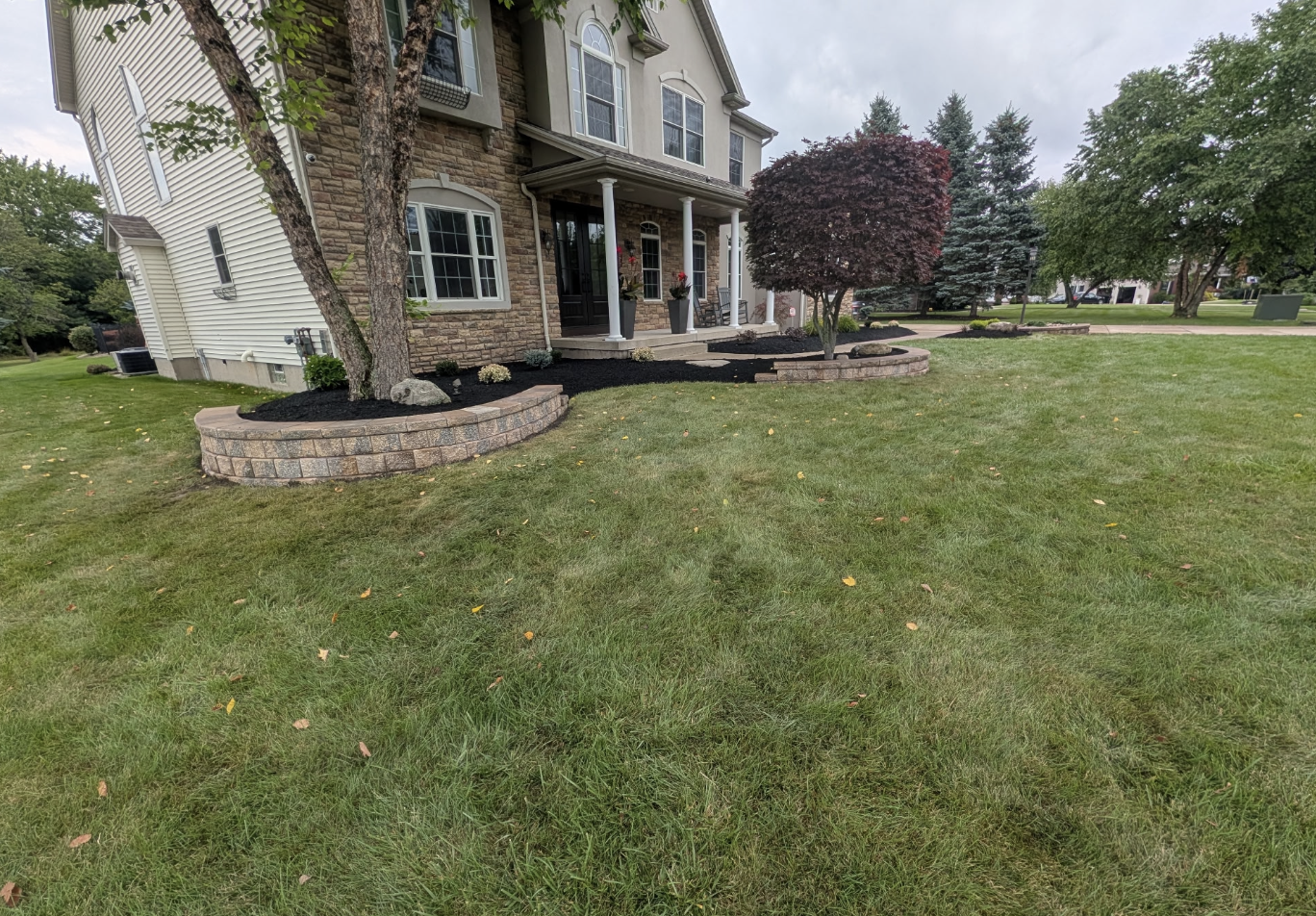 Completed Grand Island landscaping project featuring new landscape walls, fresh sod, mulch beds, and plantings by Kielty Landscaping