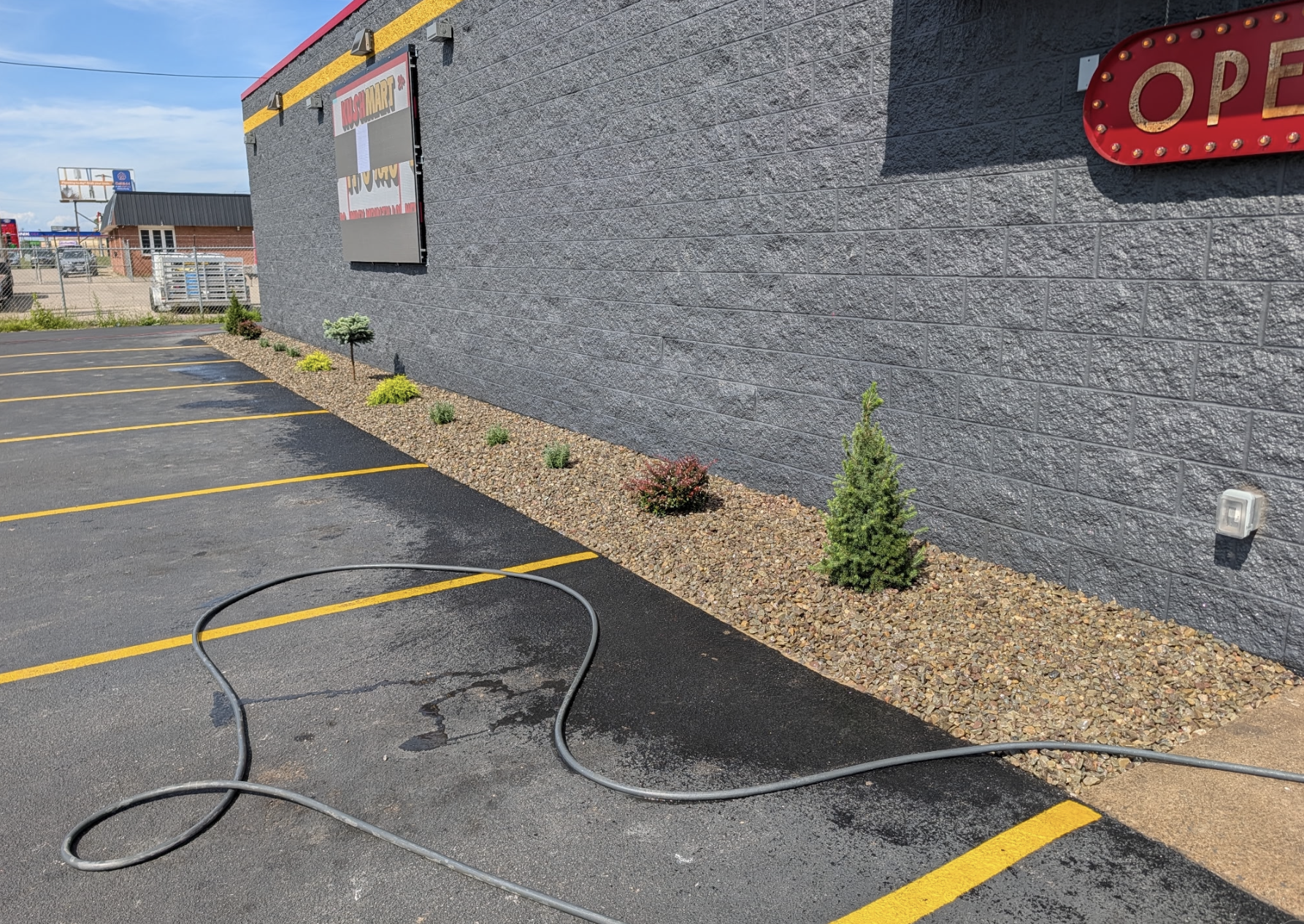 Commercial landscaping with decorative stone beds and new shrub installation