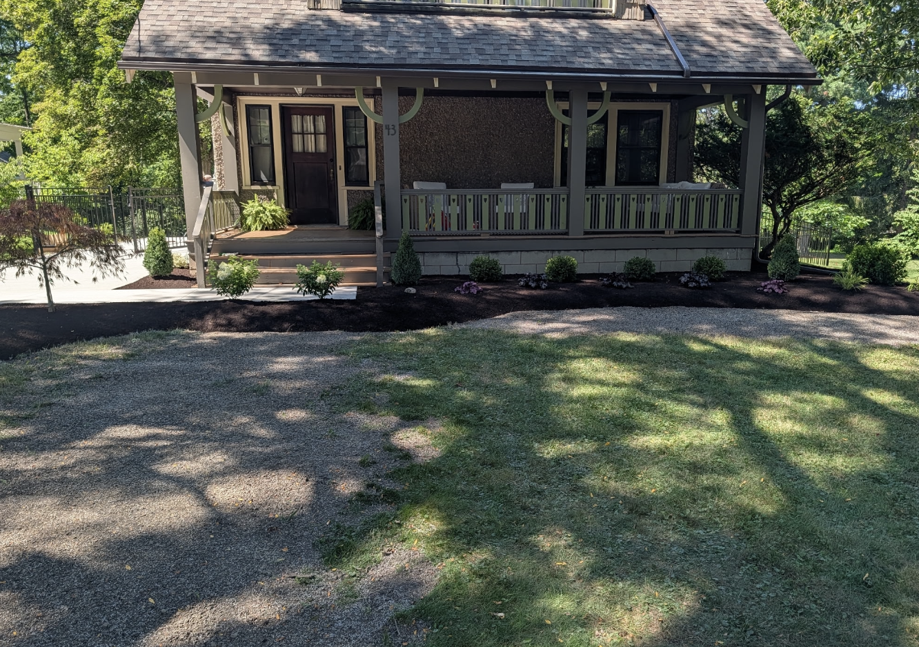 Fresh landscaping installation around front porch and lawn by Kielty Landscaping in West Seneca NY