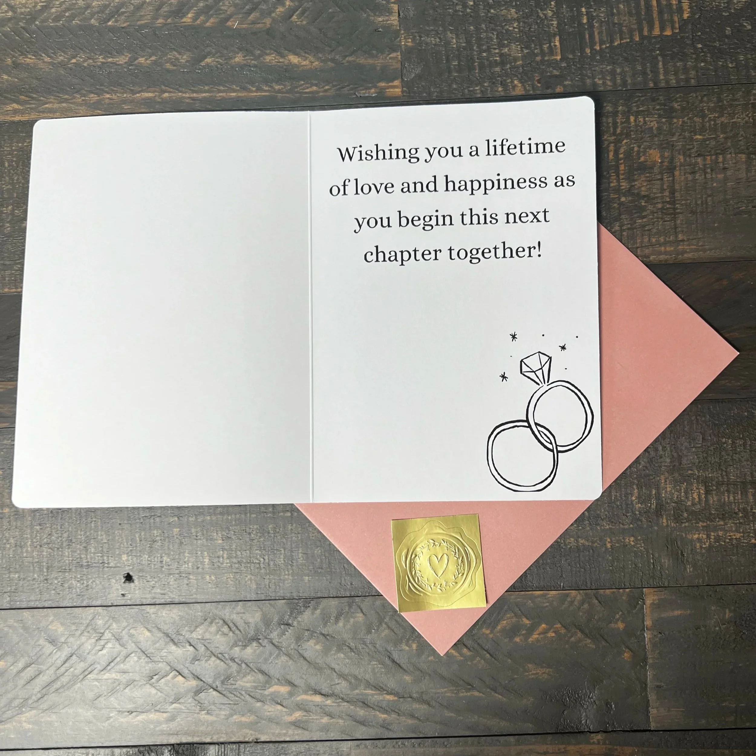Open You're Engaged! greeting card with coordinating blush pink envelope and gold wax seal style sticker.