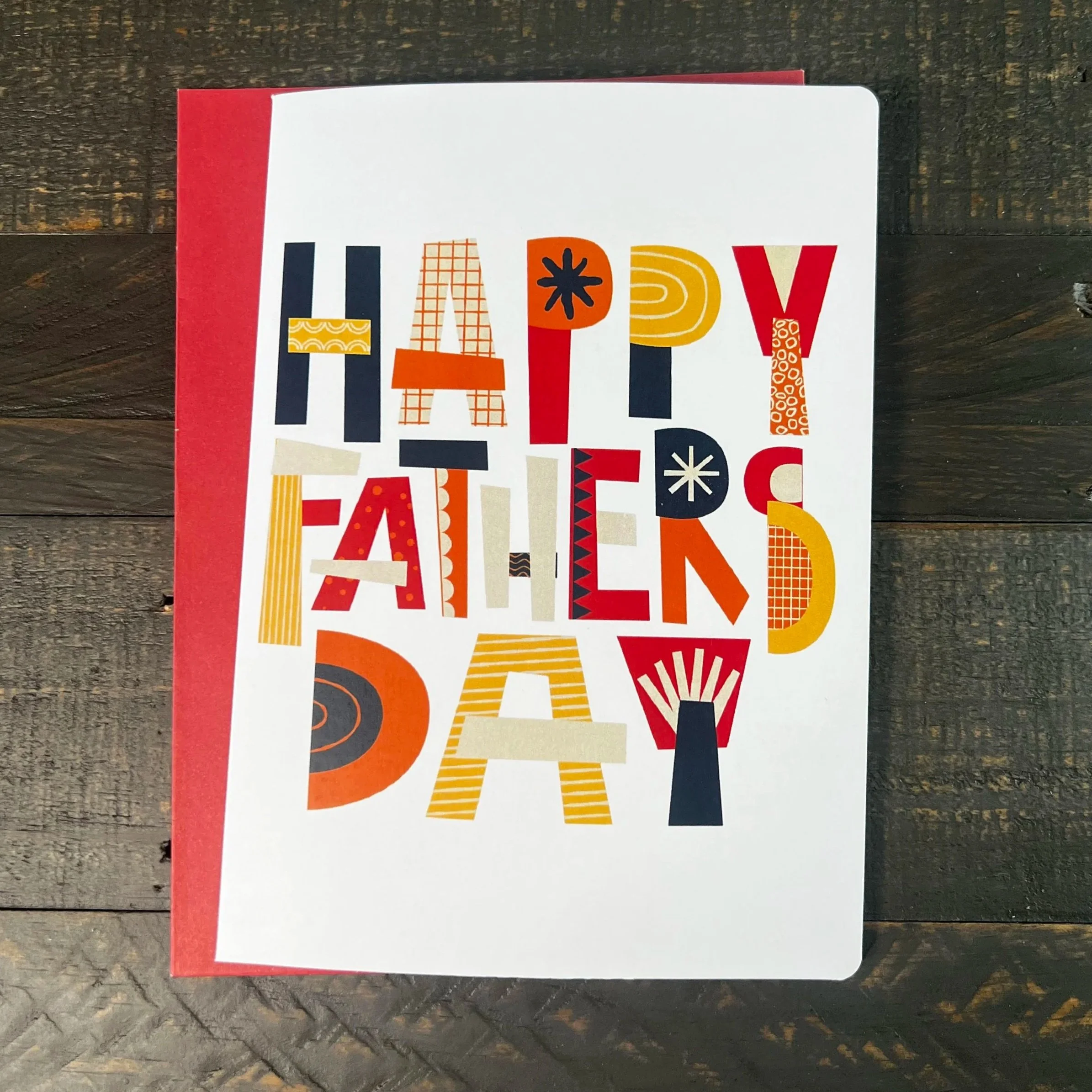 Retro-inspired Father’s Day card with colorful typography and illustrations on wood background