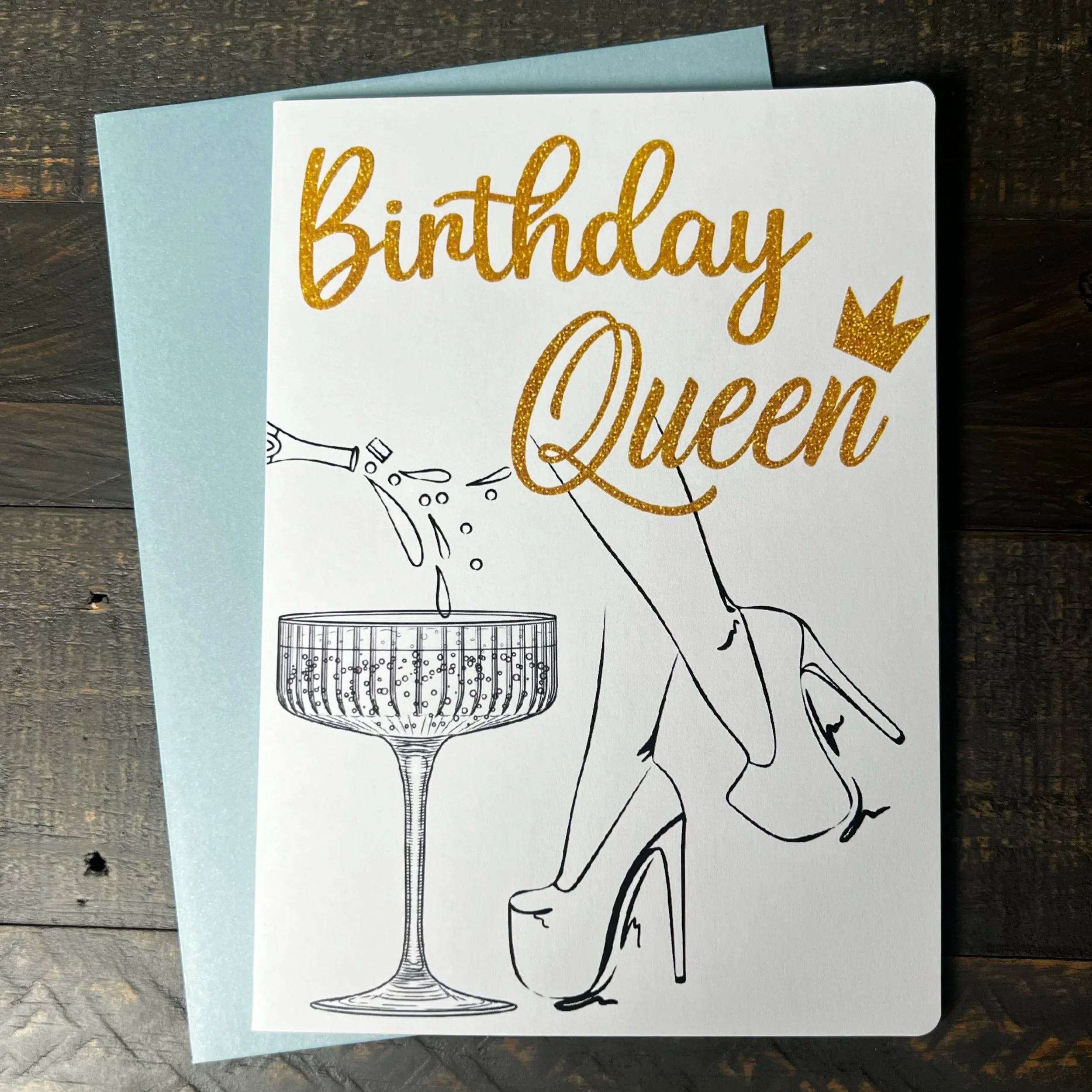 Front of Birthday Queen greeting card with coordinating soft blue envelope.