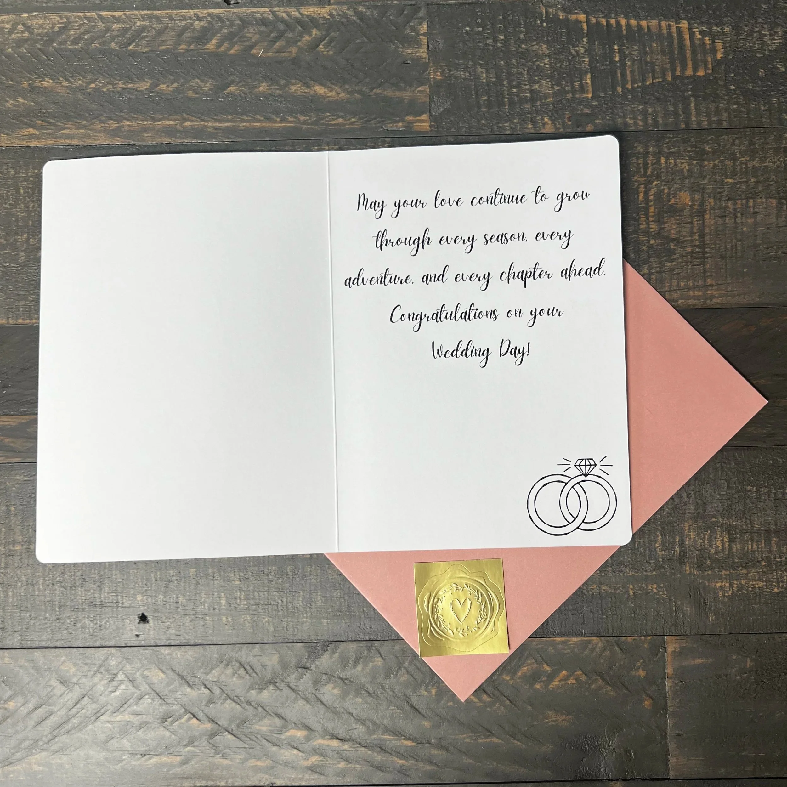 Open Just Married Wedding Card with coordinating blush pink envelope and gold wax seal style sticker.