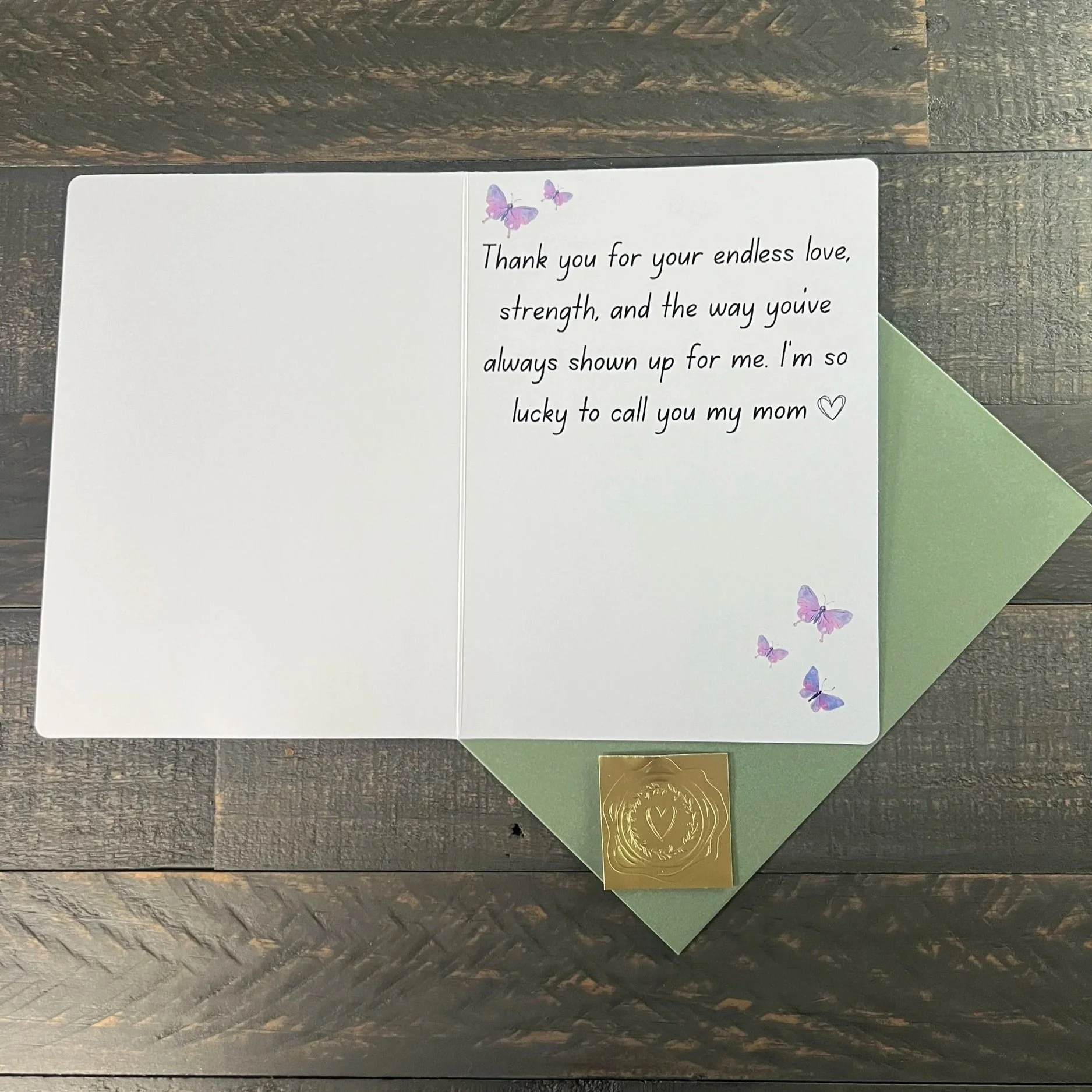 Inside of Mother’s Day card with heartfelt message and butterfly accents, displayed with sage green envelope and gold wax seal sticker