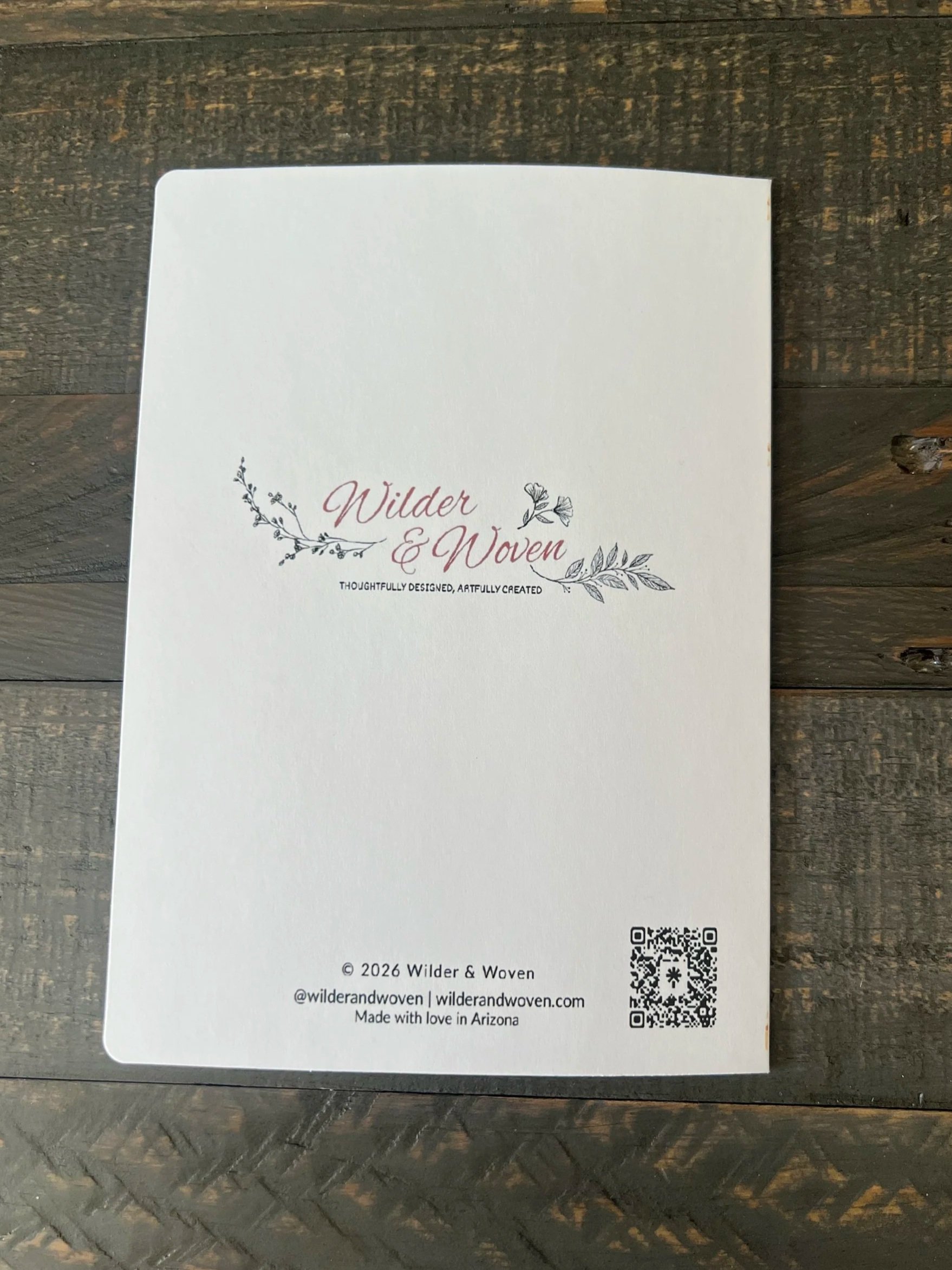 Back of greeting card featuring Wilder & Woven logo, brand tagline, and QR code on a clean white background