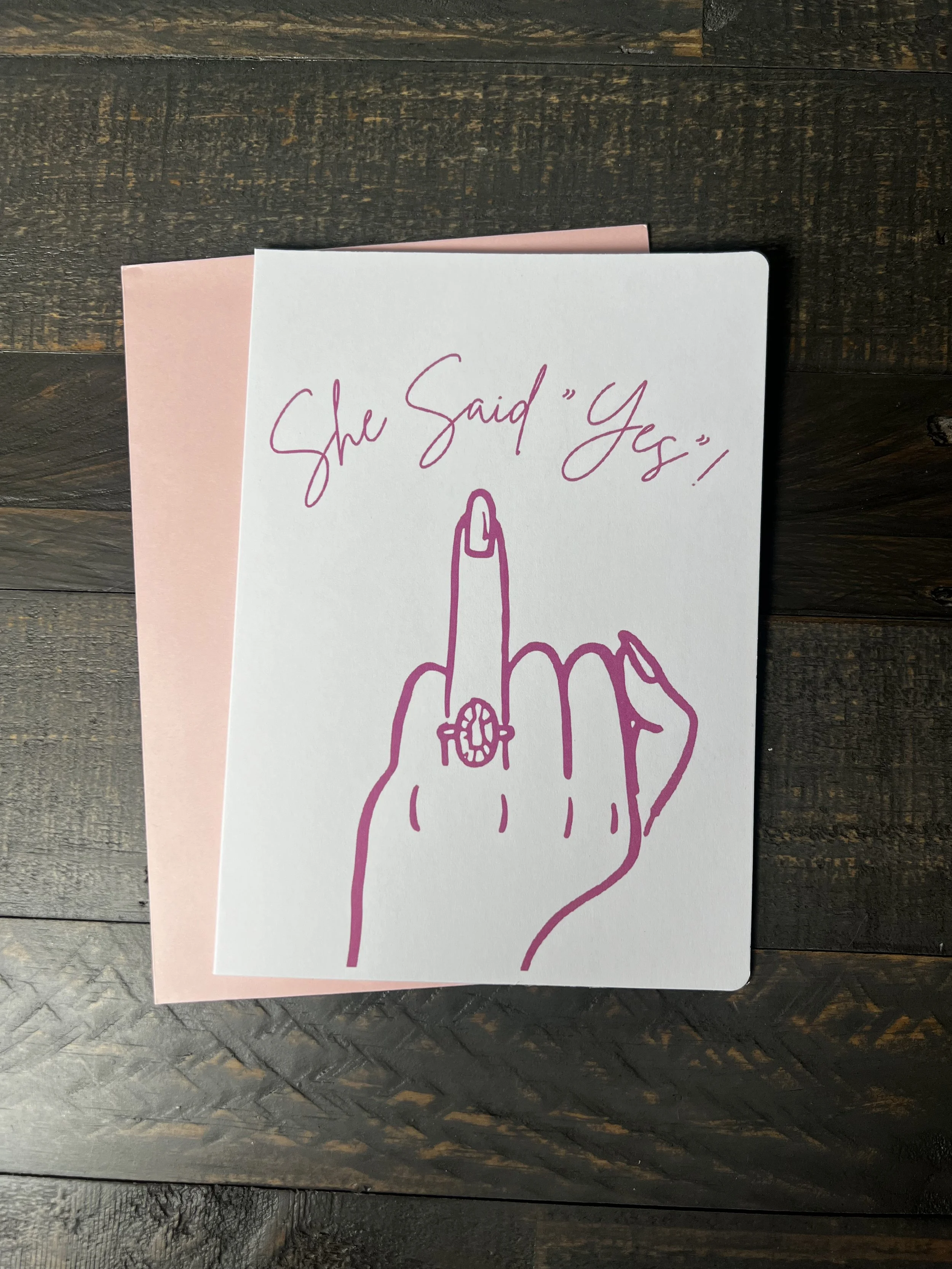 Front of She Said Yes! engagement card with coordinating blush pink envelope.