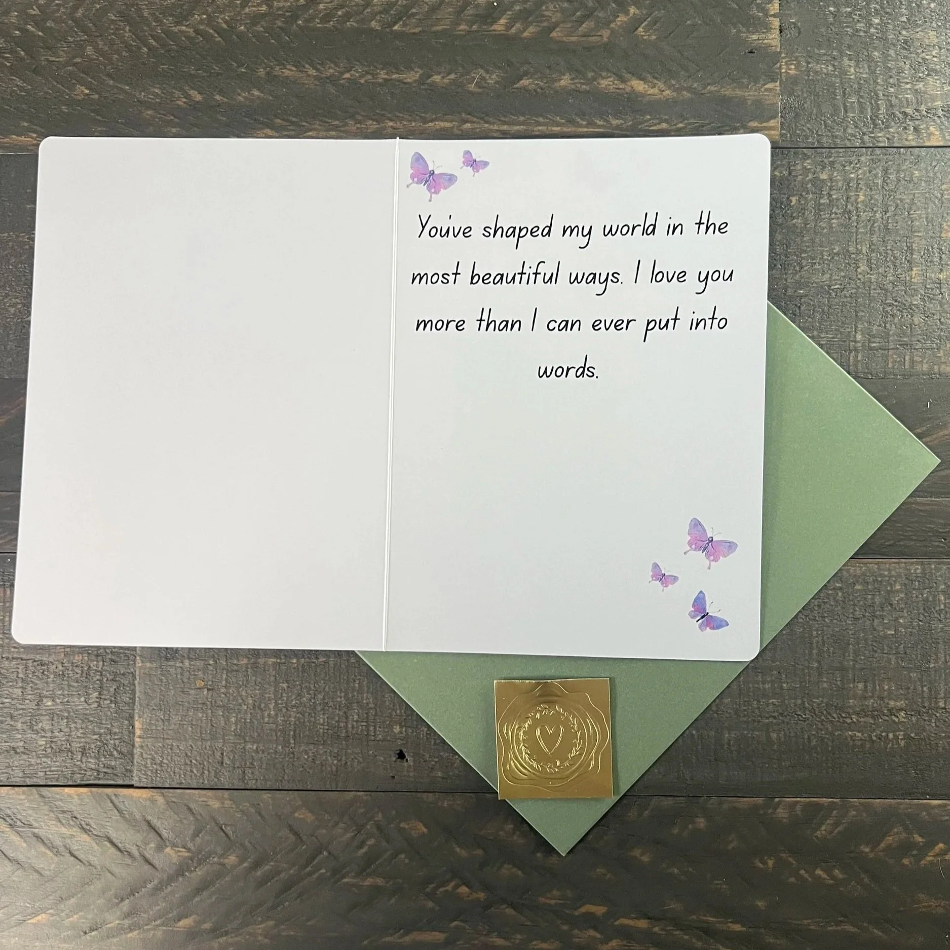 Inside of Mother’s Day card with heartfelt message and butterfly accents, displayed with sage green envelope and gold wax seal sticker