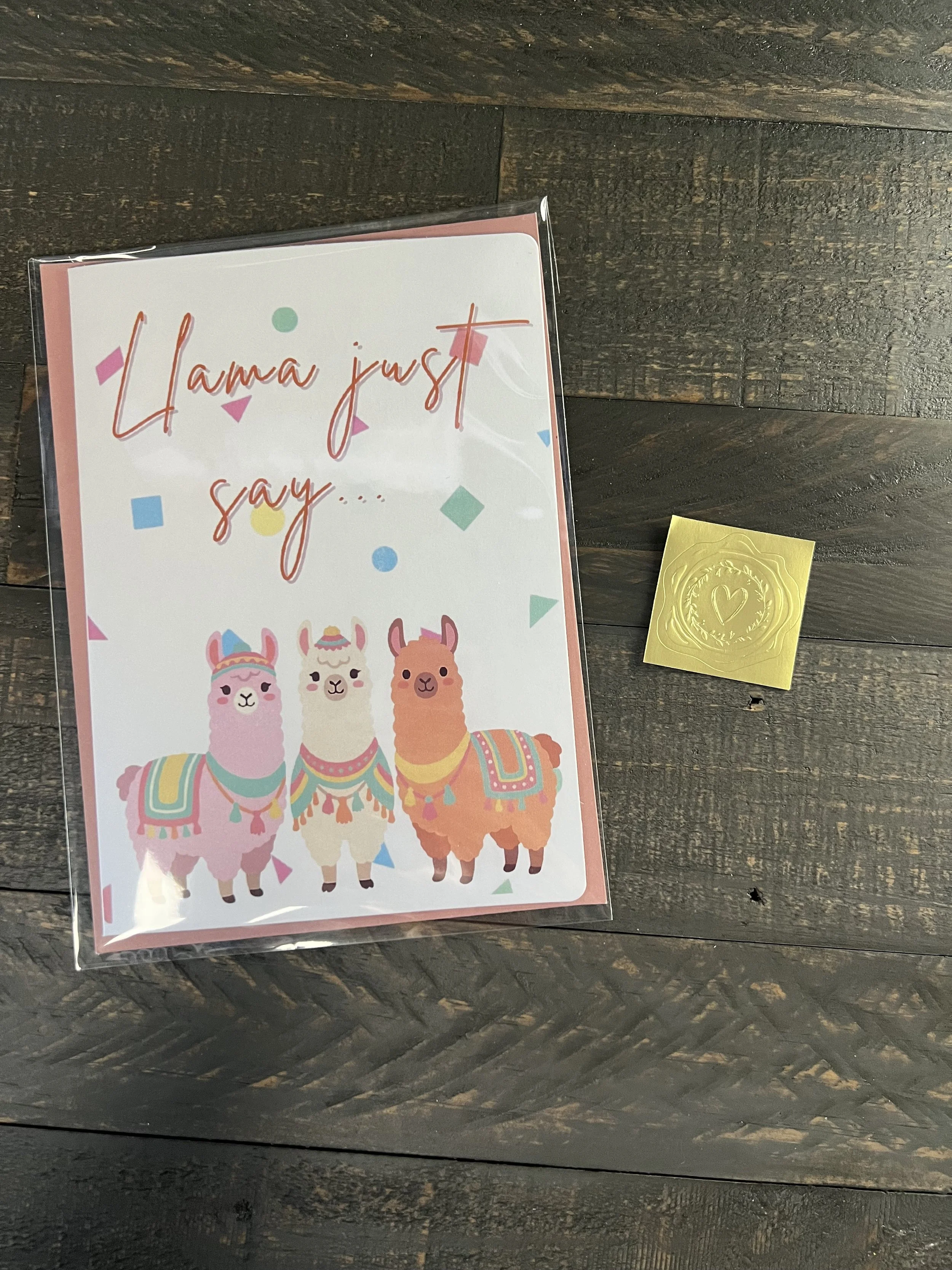 Llama birthday card with coordinating envelope and gold wax seal sticker styled on rustic surface