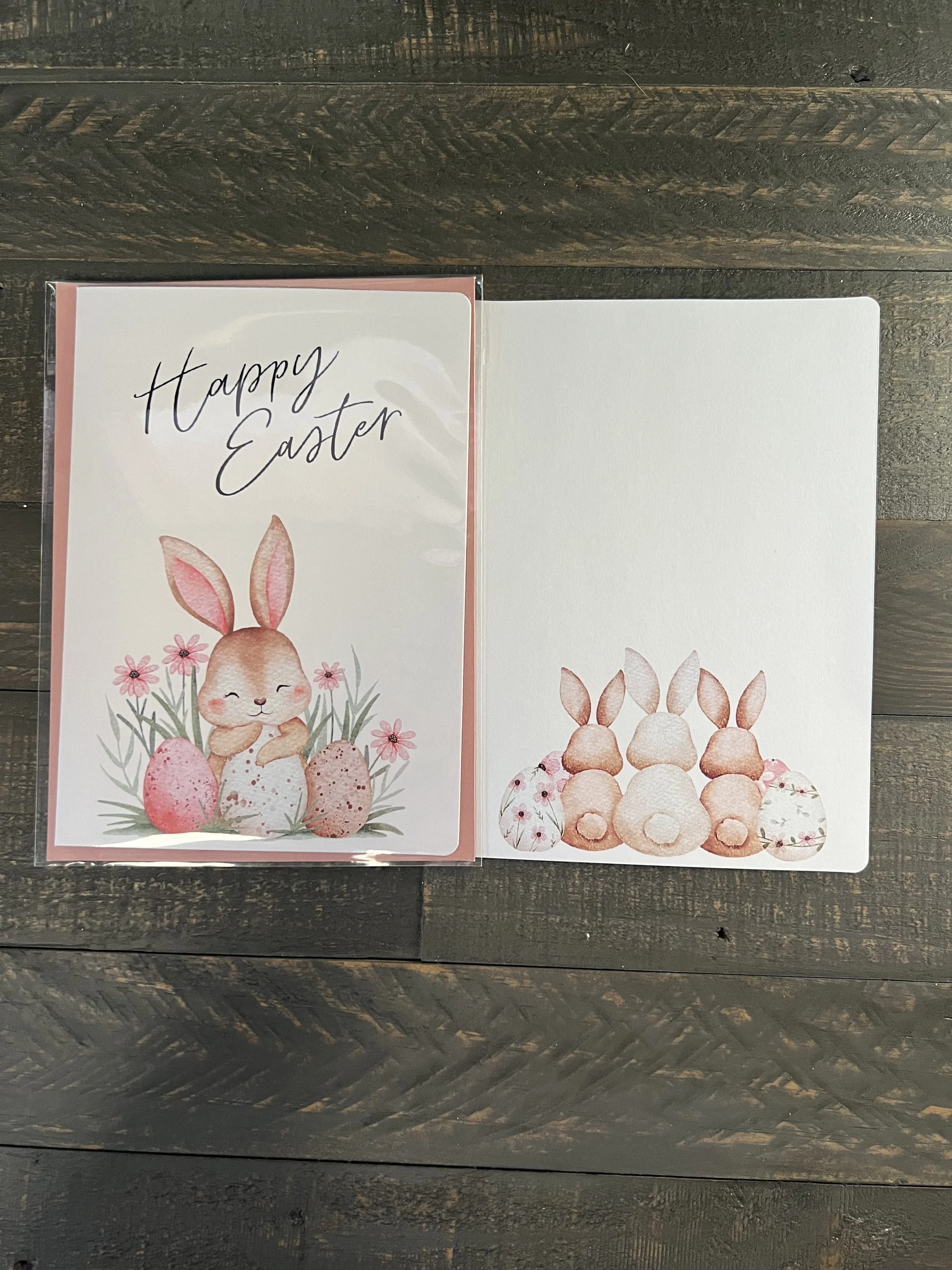 Open Easter card showing blank inside with bunny and floral design on front