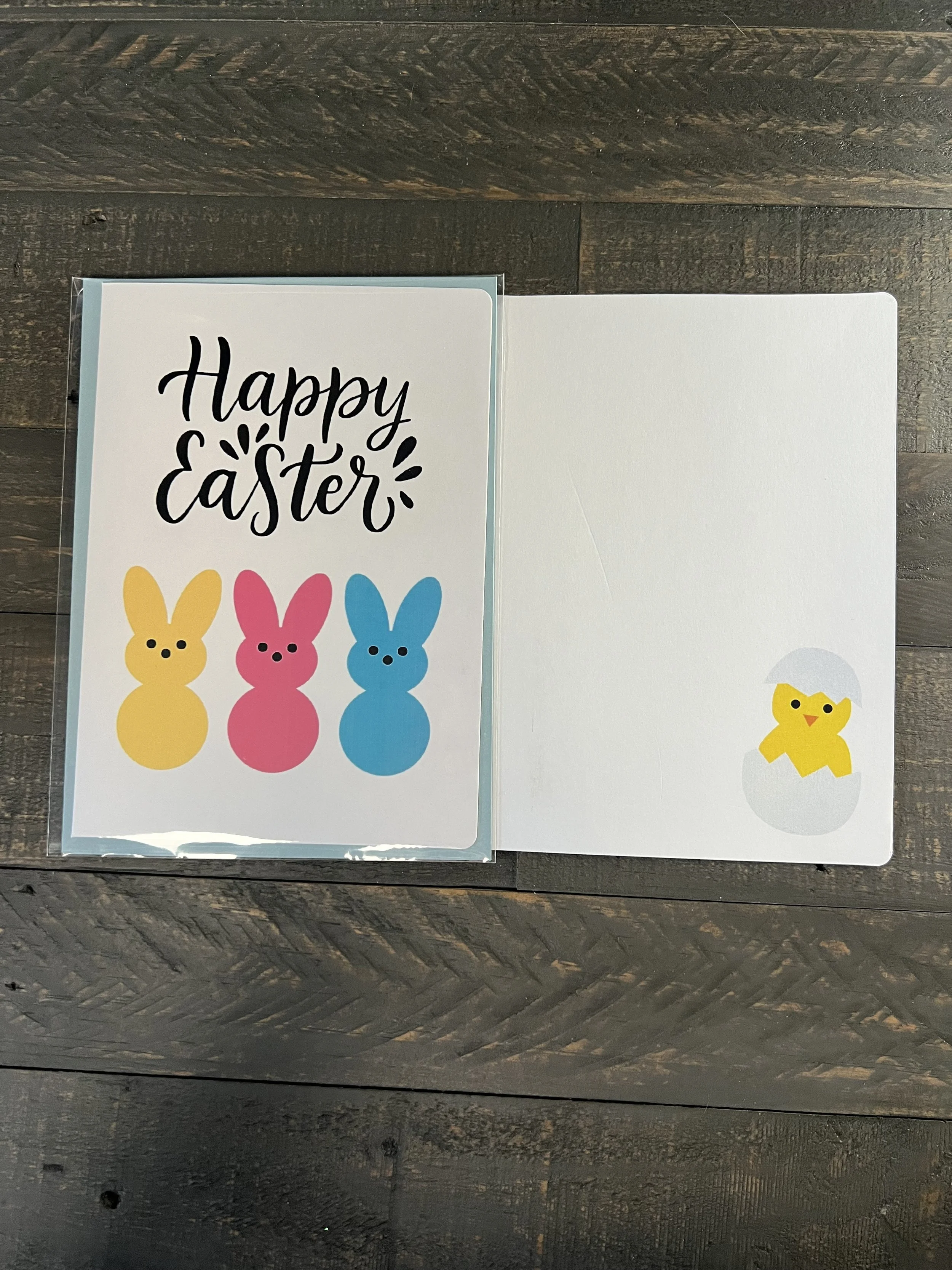 Open Easter card showing blank inside with colorful bunny design on front