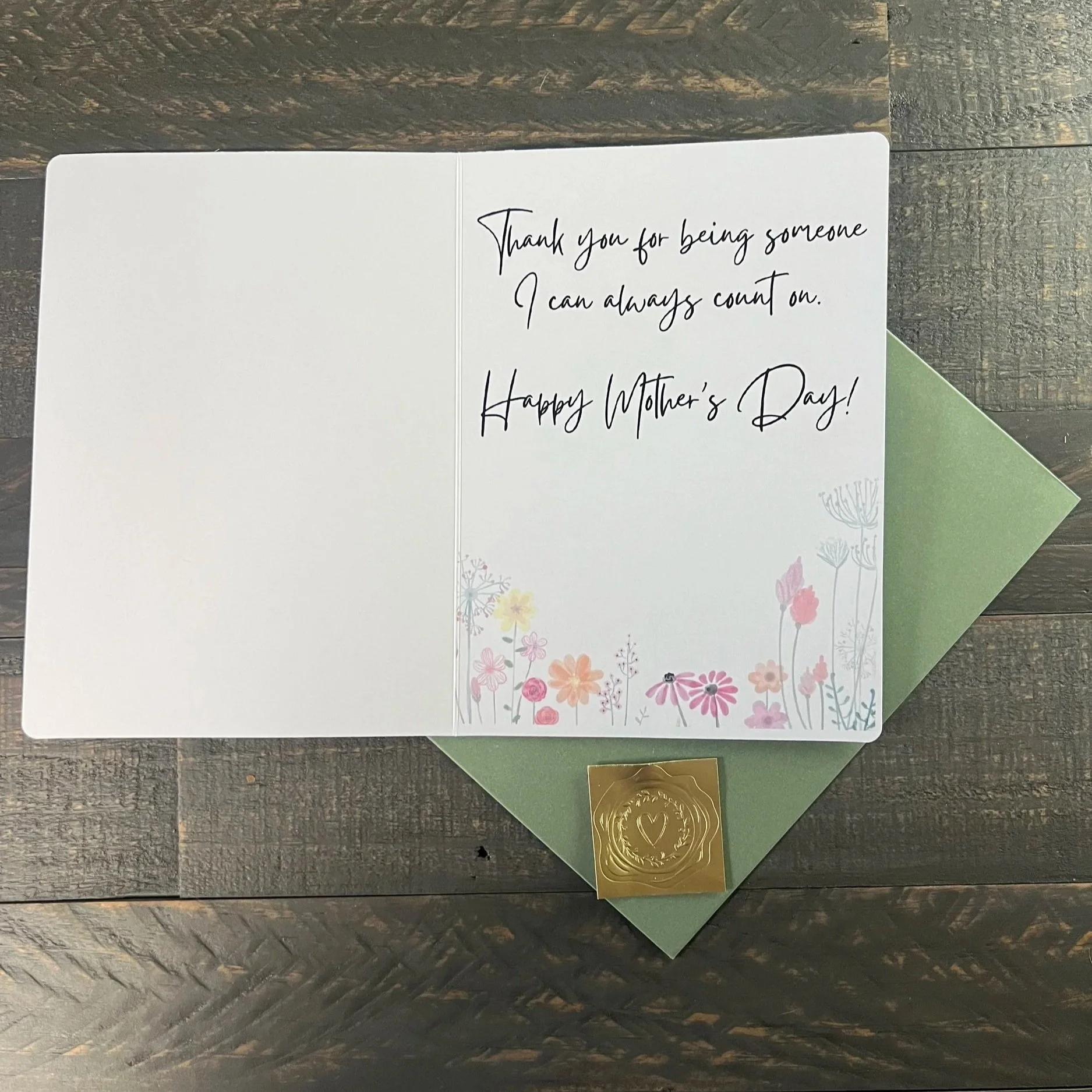 Inside of Mother’s Day card with heartfelt message and soft floral border, displayed with sage green envelope and gold wax seal sticker