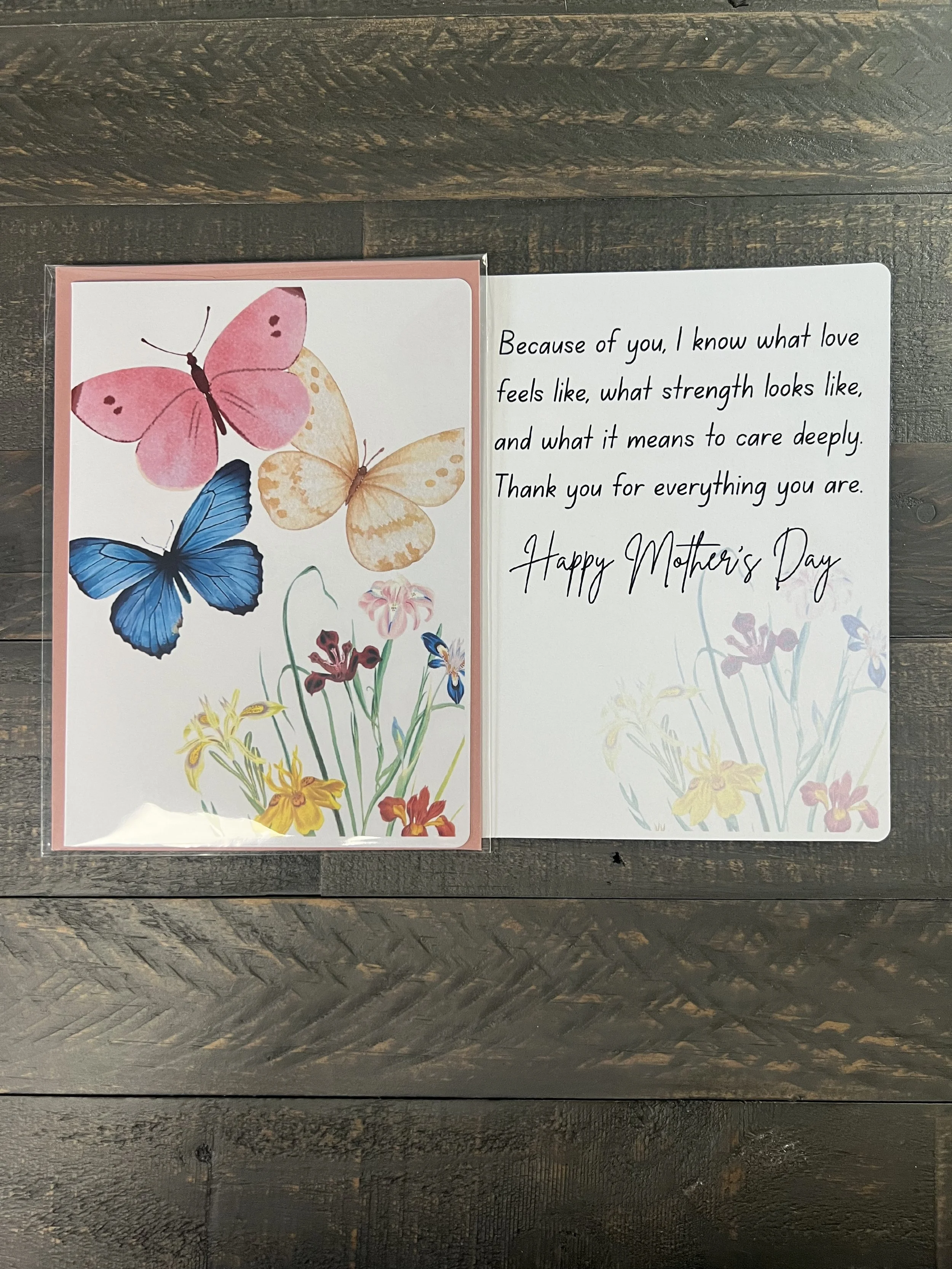 Open Mother’s Day card showing butterfly and floral front design with inside message about love, strength, and appreciation