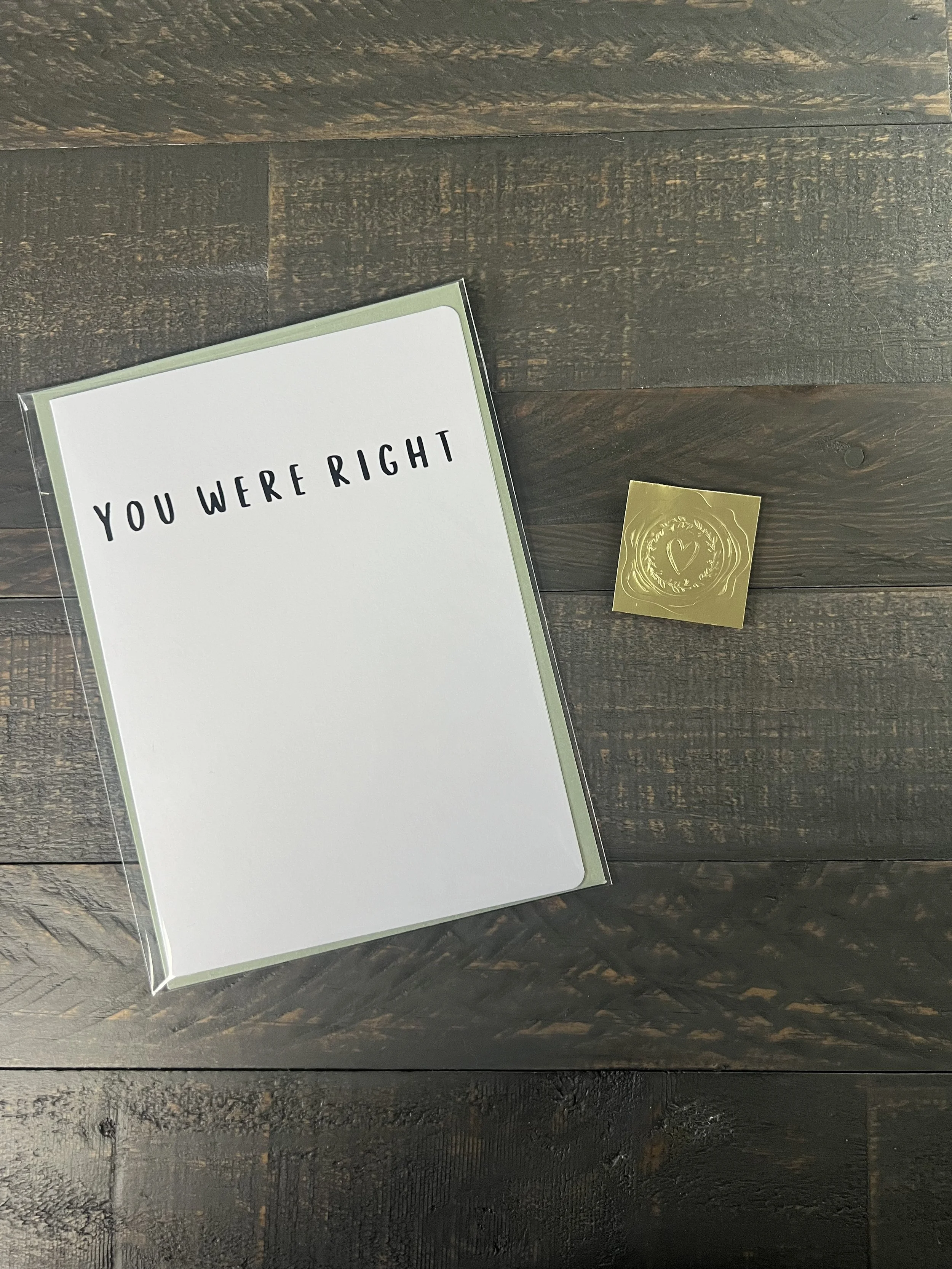 Packaged funny Mother’s Day card with simple typography design, sage green envelope, and gold wax seal sticker