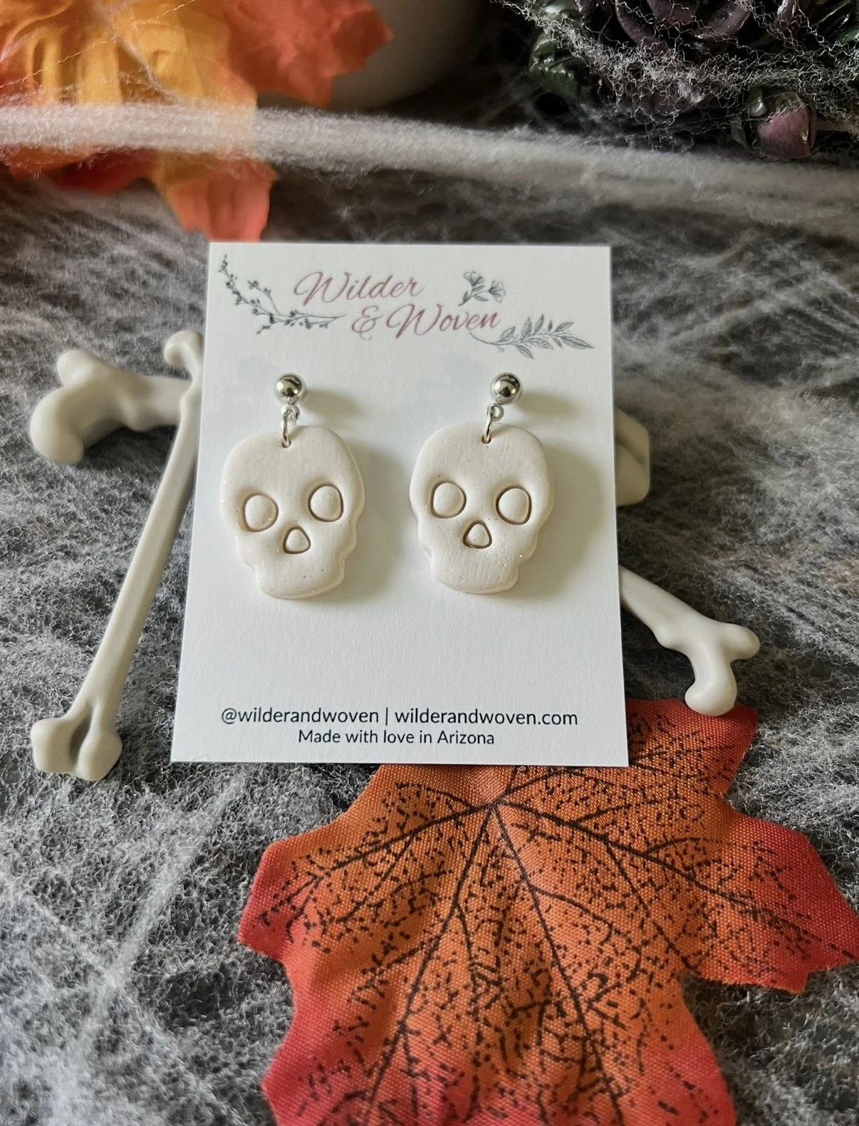 Glitter white polymer clay skull dangle earrings with silver-tone posts by Wilder & Woven.