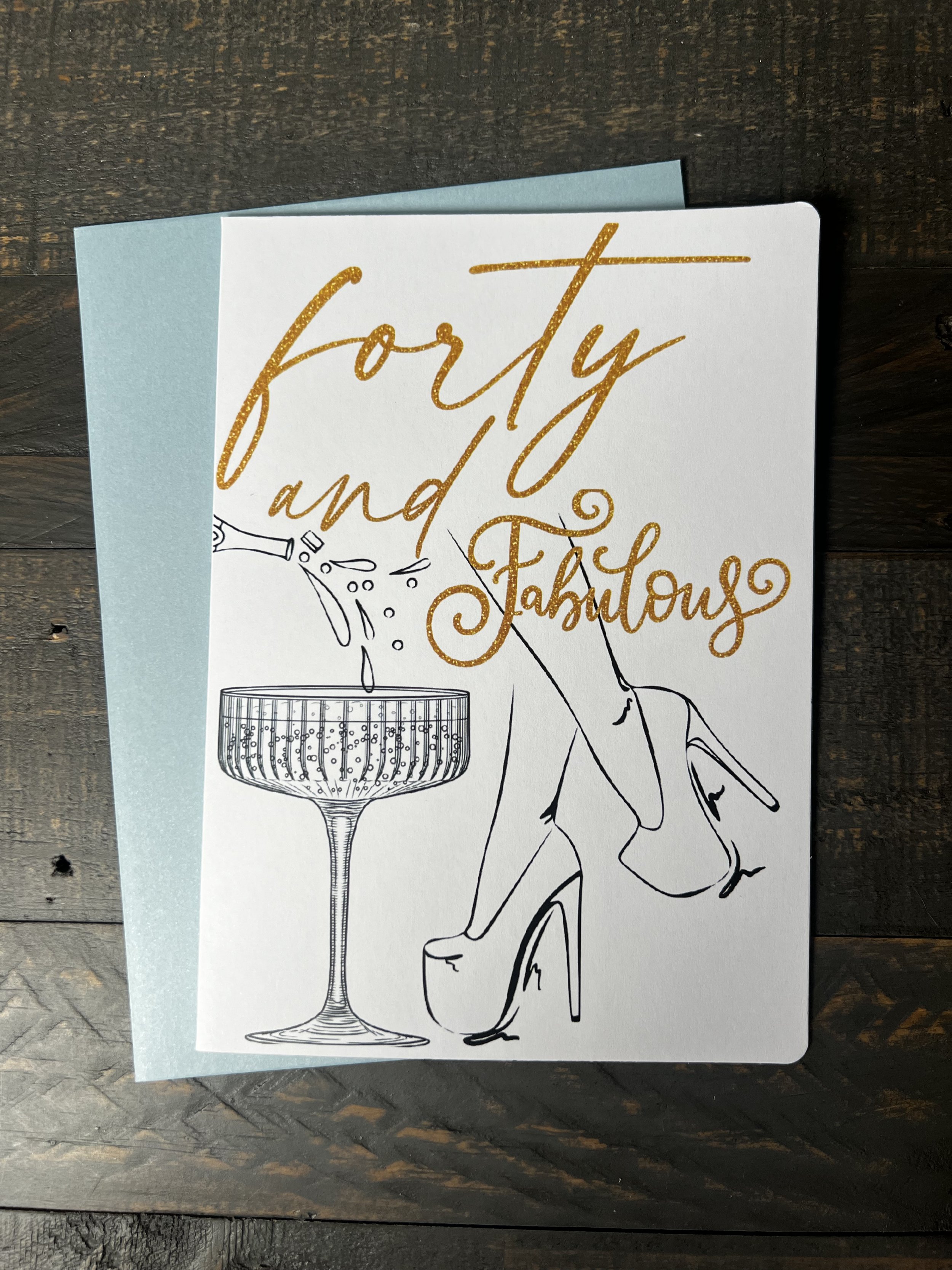 Forty & Fabulous birthday greeting card featuring champagne glass and elegant heels illustration.