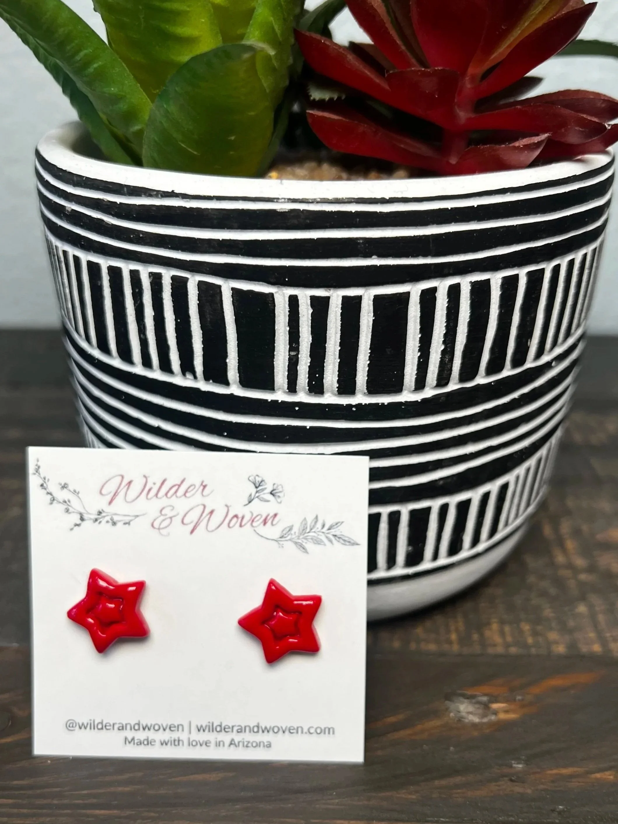 Handmade red polymer clay star stud earrings displayed on a Wilder & Woven earring card.