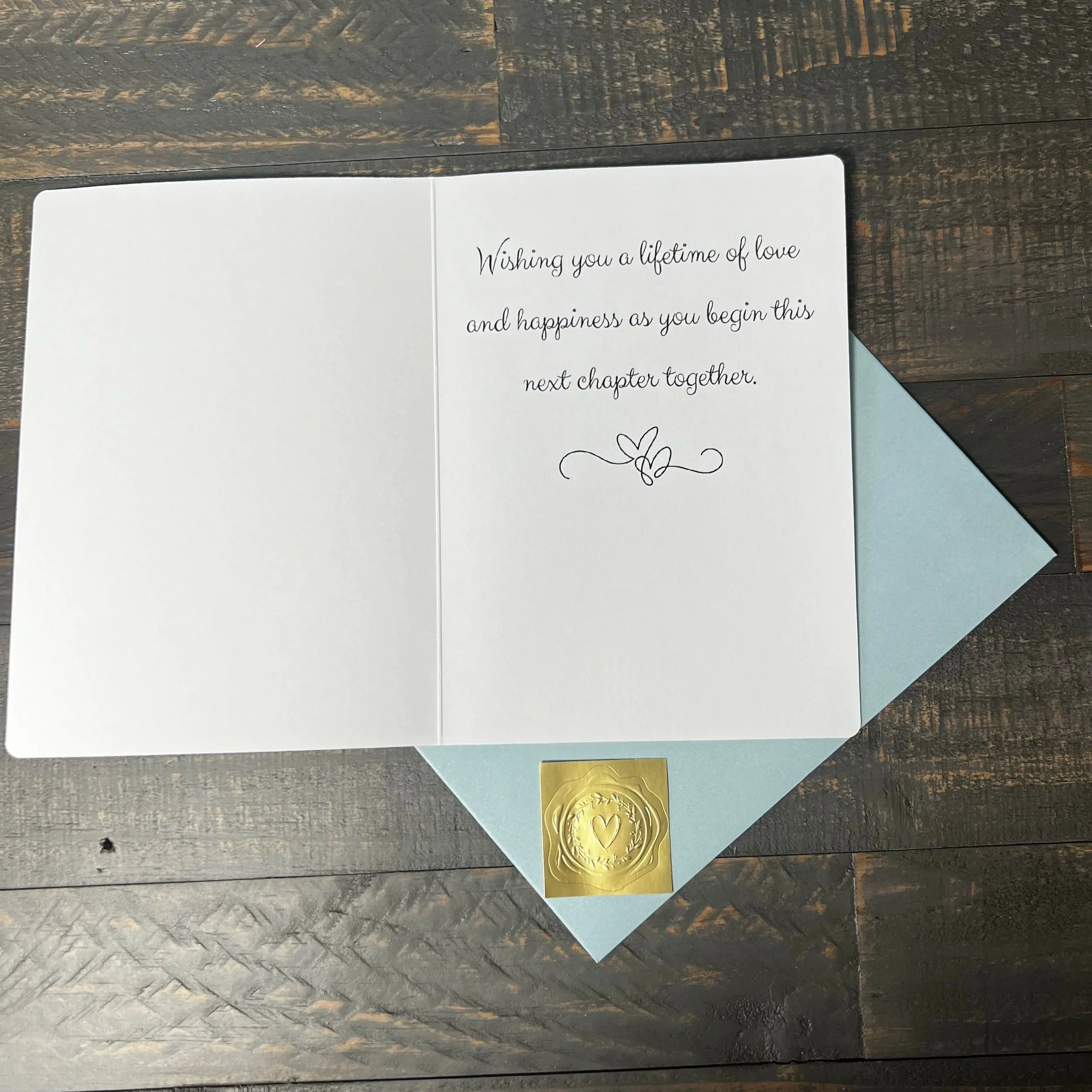 Open Mr. & Mrs. wedding greeting card with coordinating soft blue envelope and gold wax seal style sticker.
