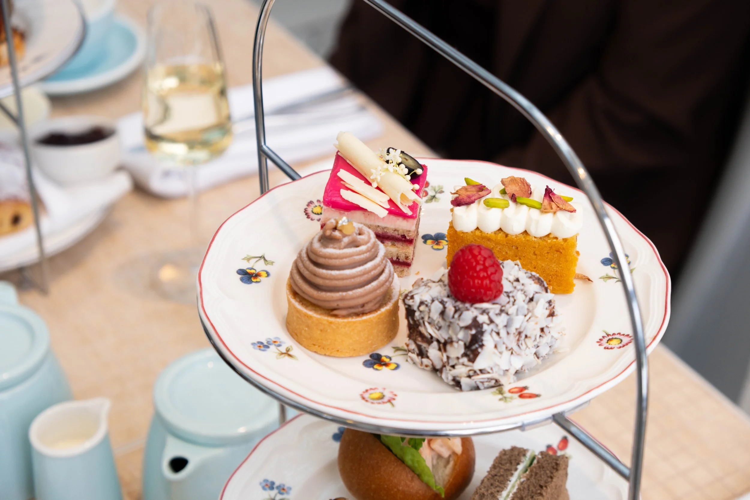 Sweet tier of Shutters afternoon tea featuring almond cake and chocolate lamington