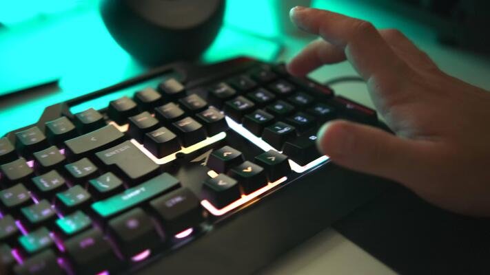 young-gamer-plays-a-game-or-typing-on-colorful-keyboard-close-up-clip-player-uses-gaming-illuminated-keyboard-concept-of-cybersport-video.jpg
