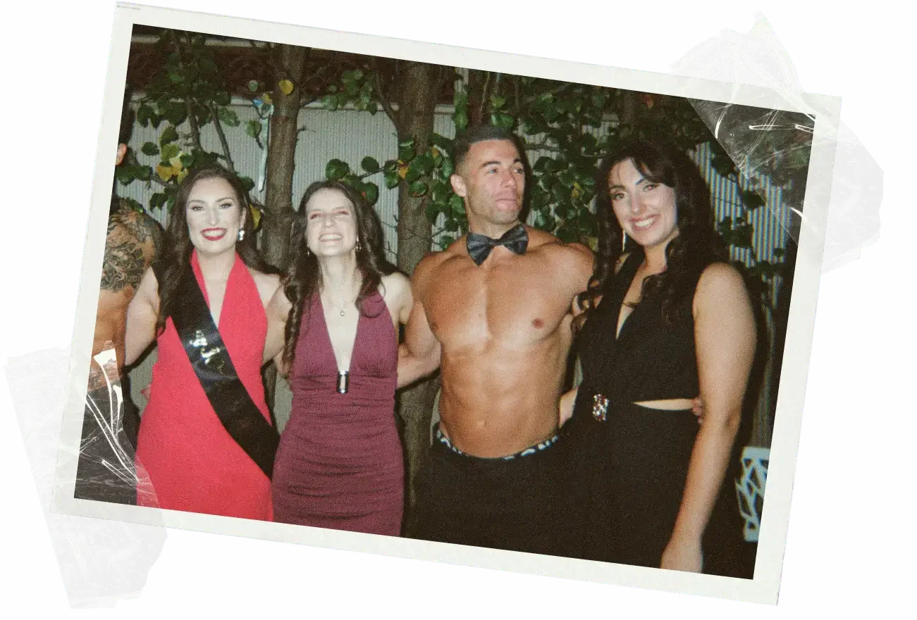 A 1-800 HOT COPS shirtless bartender mixing spritzes from the group's own ingredients at a Heathcote winery-stay hens weekend.