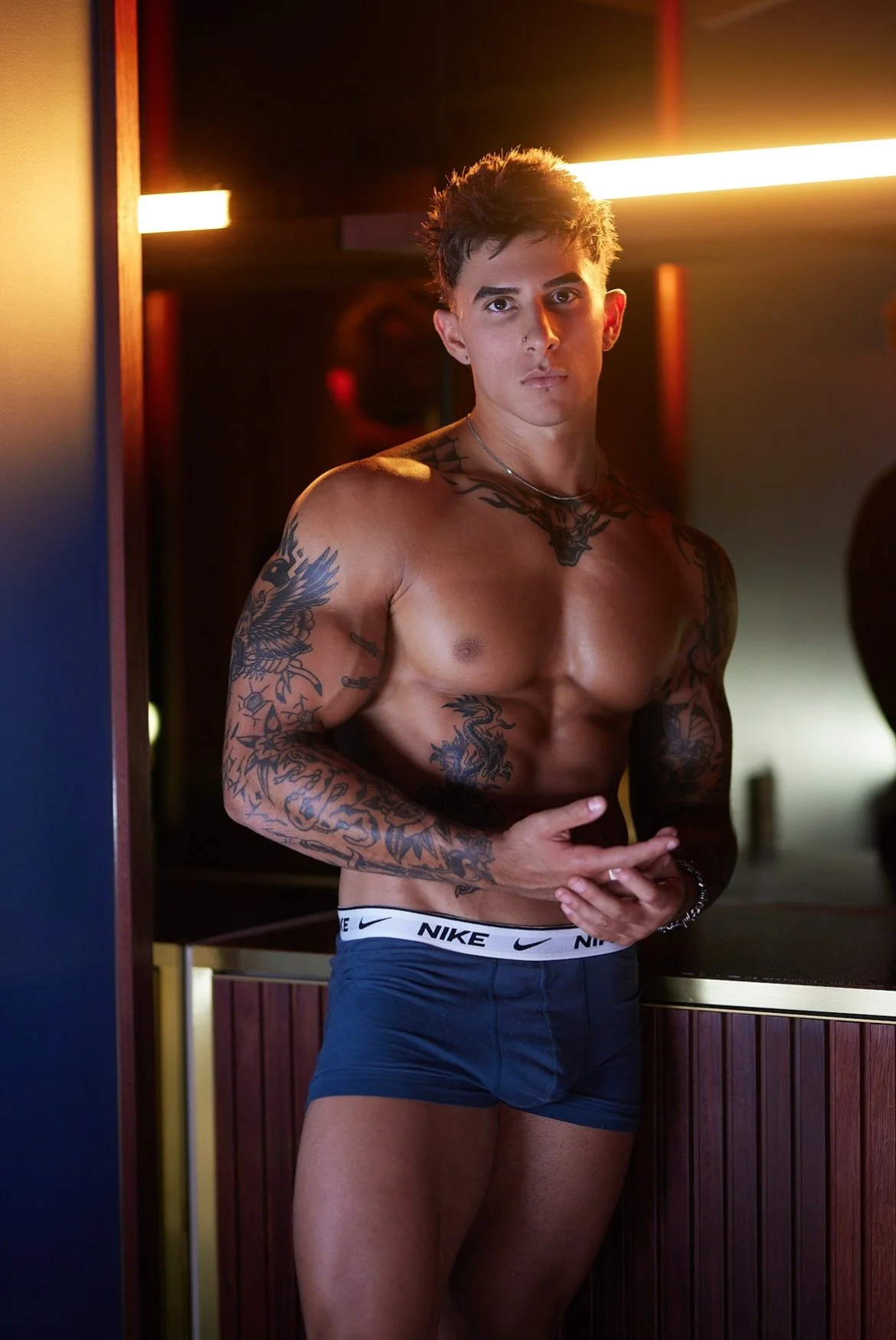 Chad Stallion shirtless under warm bar lighting - Hot Cop strip show performer in Melbourne.