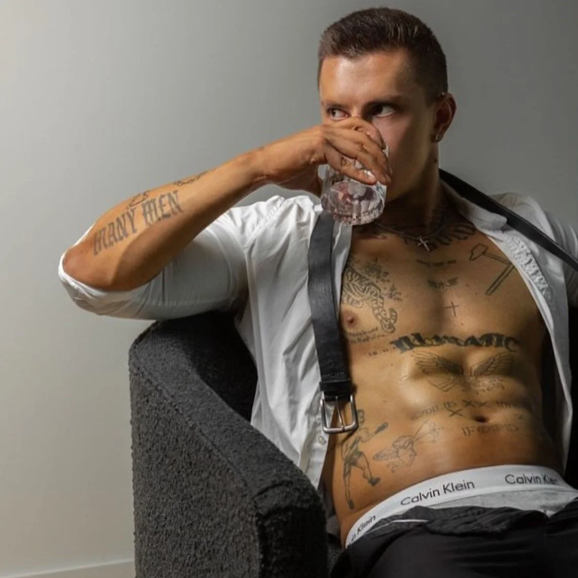 vintage photo of Geelong and melbourne male stripper dirk diggler holding a police vest over his shoulder after a routine at a hens party