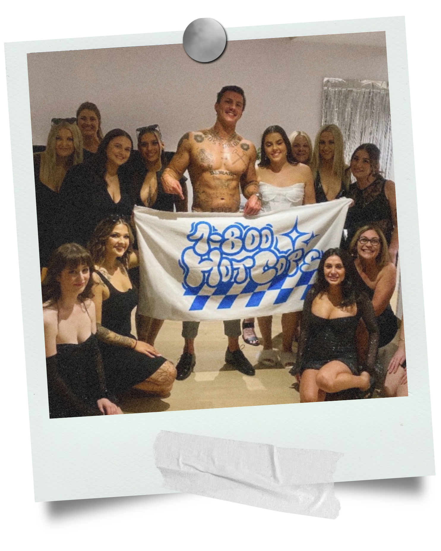 Sydney hens party group photo with a 1-800 HOT COPS entertainer and banner after an in-room performance.