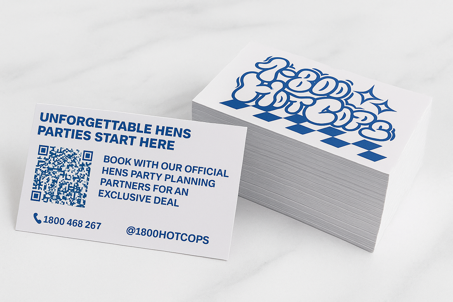 Business card with text promoting hen parties, a QR code, a phone number, and a social media handle, placed next to a stack of cards with a blue logo.