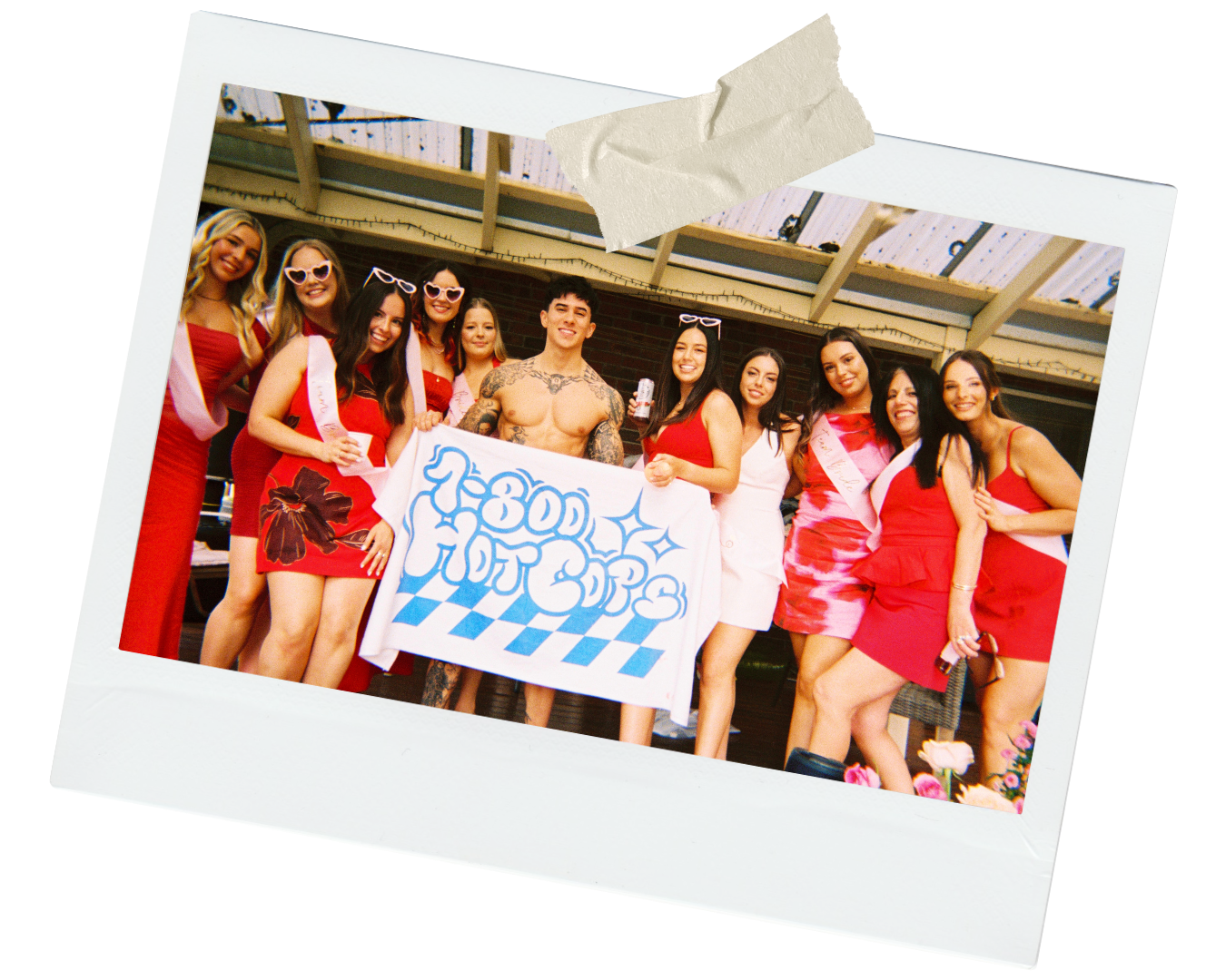 a group of happy young women wearing red dresses and sashes at a hens party posing for a group photo with their paint and sip class model from 1800hotcops