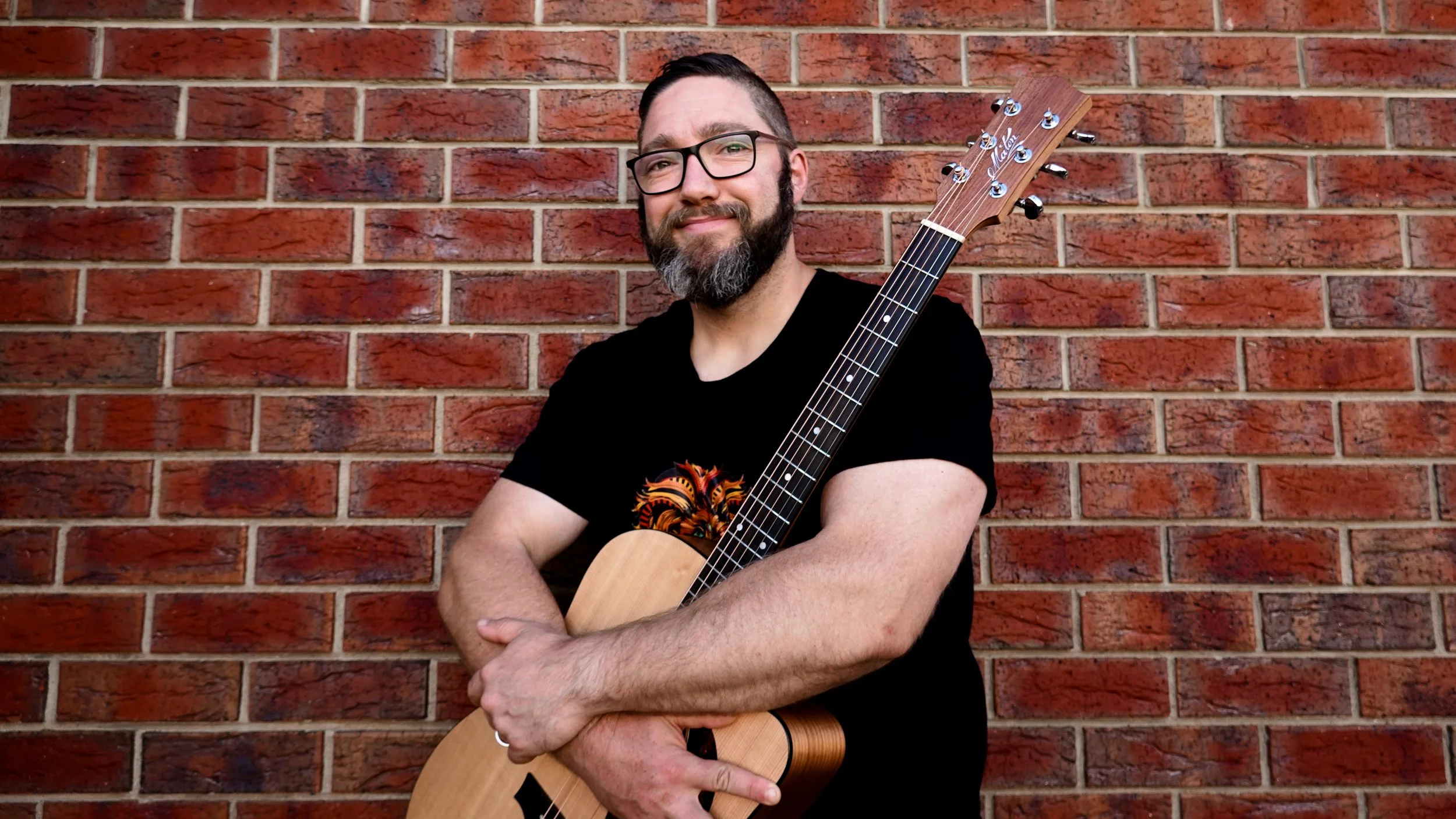 Adelaide solo artist, Jasper C Music holding acoustic guitar