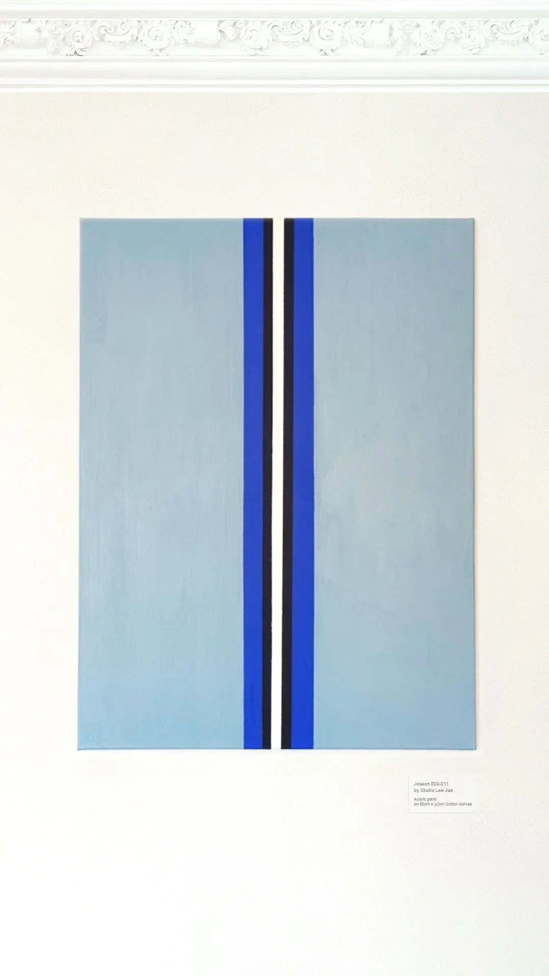 Abstract painting with vertical black, white, and blue lines on a light blue background.