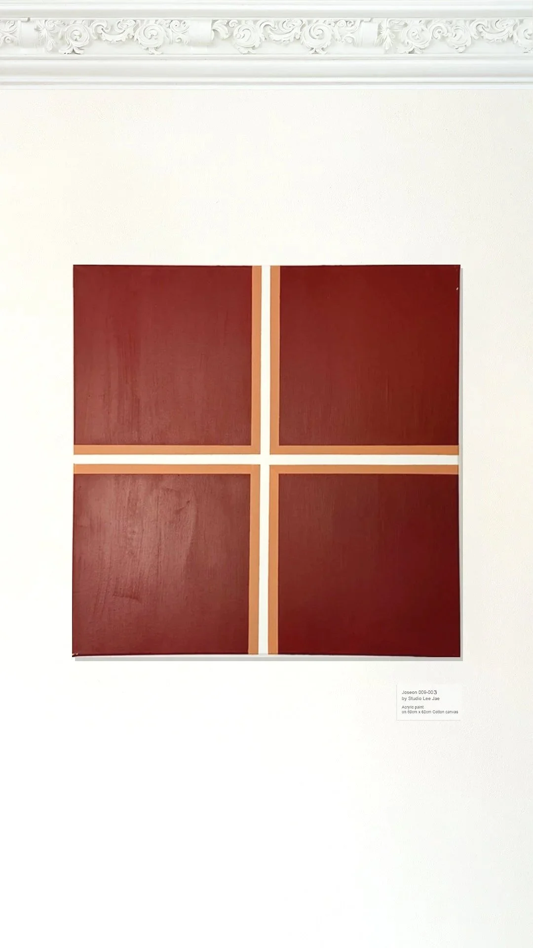 Four square acrylic paintings on a white wall with decorative molding, arranged in a 2x2 grid.