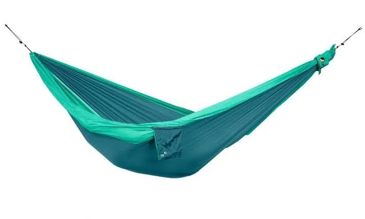 Hamac de voyage vert et bleu déplié sur fond blanc