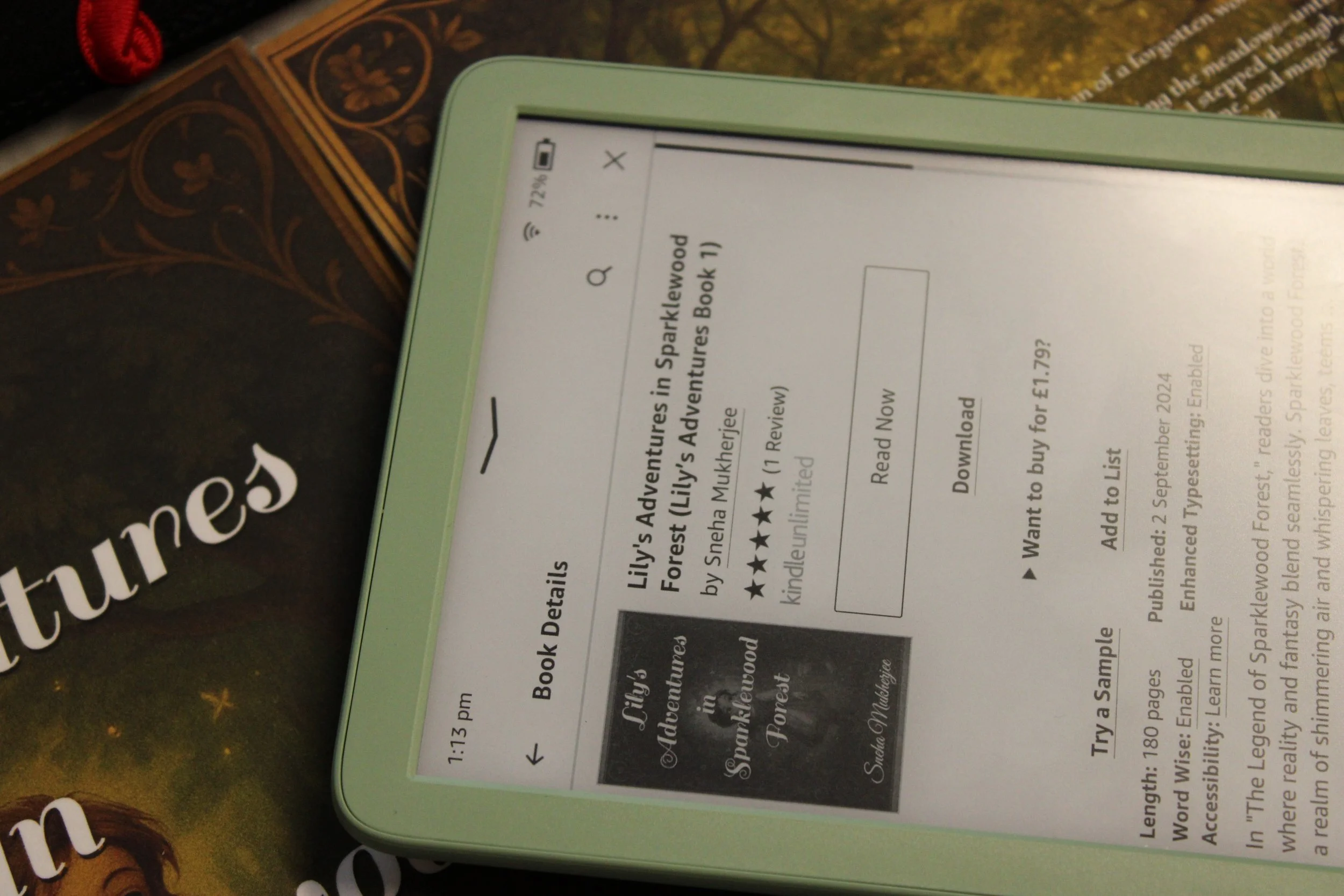 E-ink e-reader displaying the book details for 'Lily's Adventures in Sparklewood Forest' by Sneha Mukherje, including title, author, ratings, price, and purchase options. The device has a green case and is resting on a dark surface with part of a boo